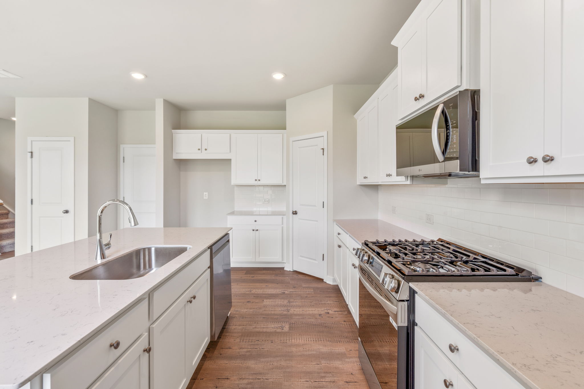 A kitchen with white cabinets.