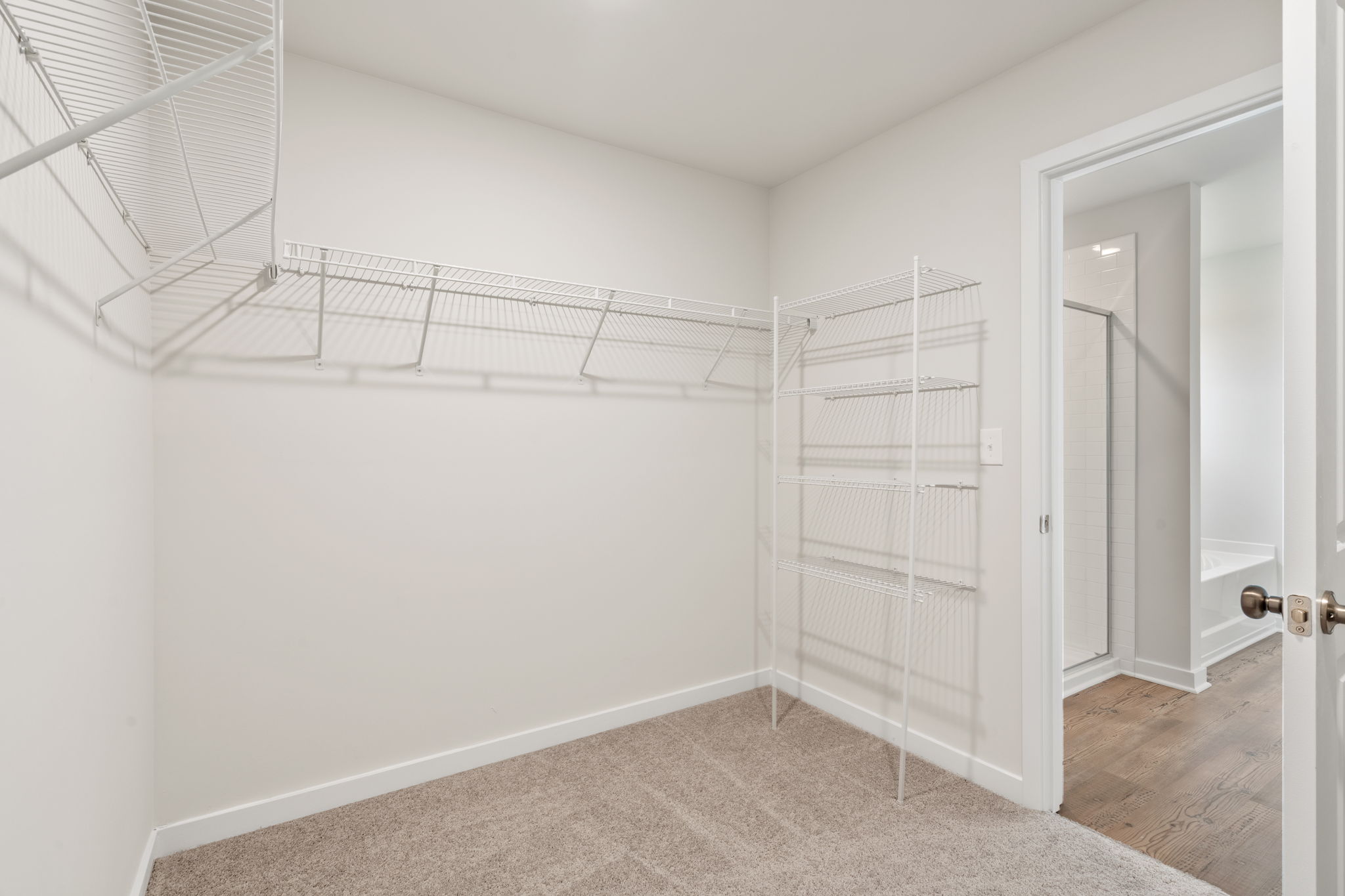 A white room with a white wall and a white door.