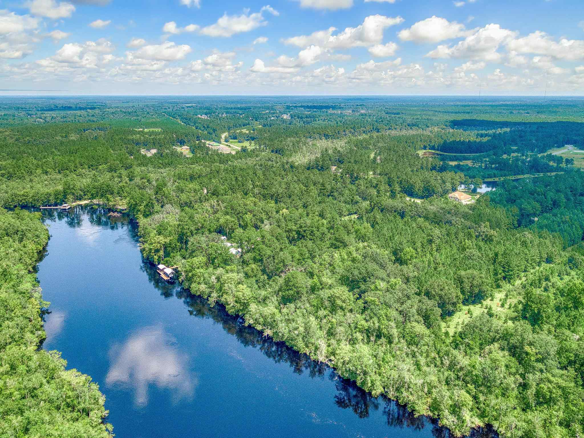 A river with trees and a boat.