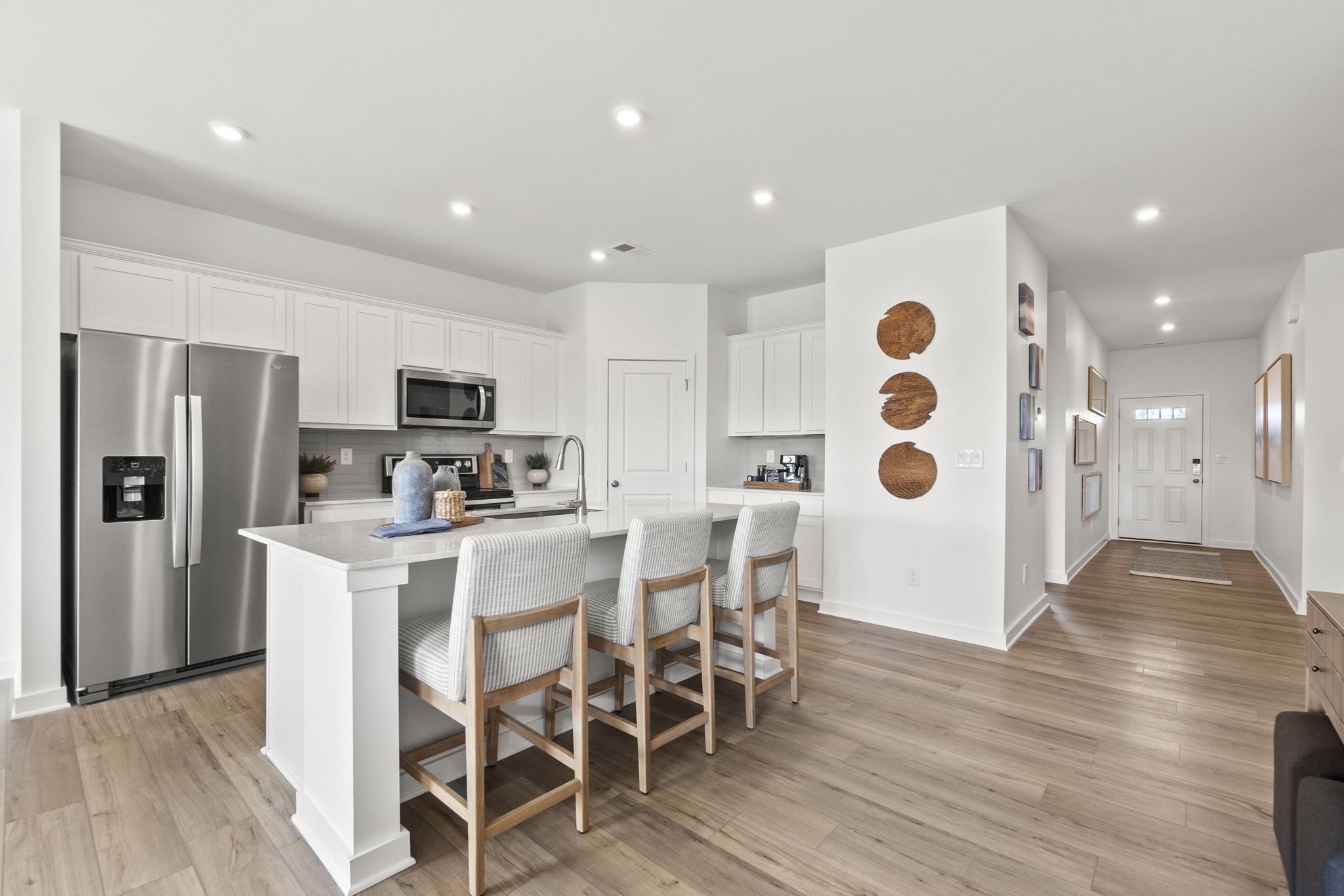 A kitchen with white cabinets.
