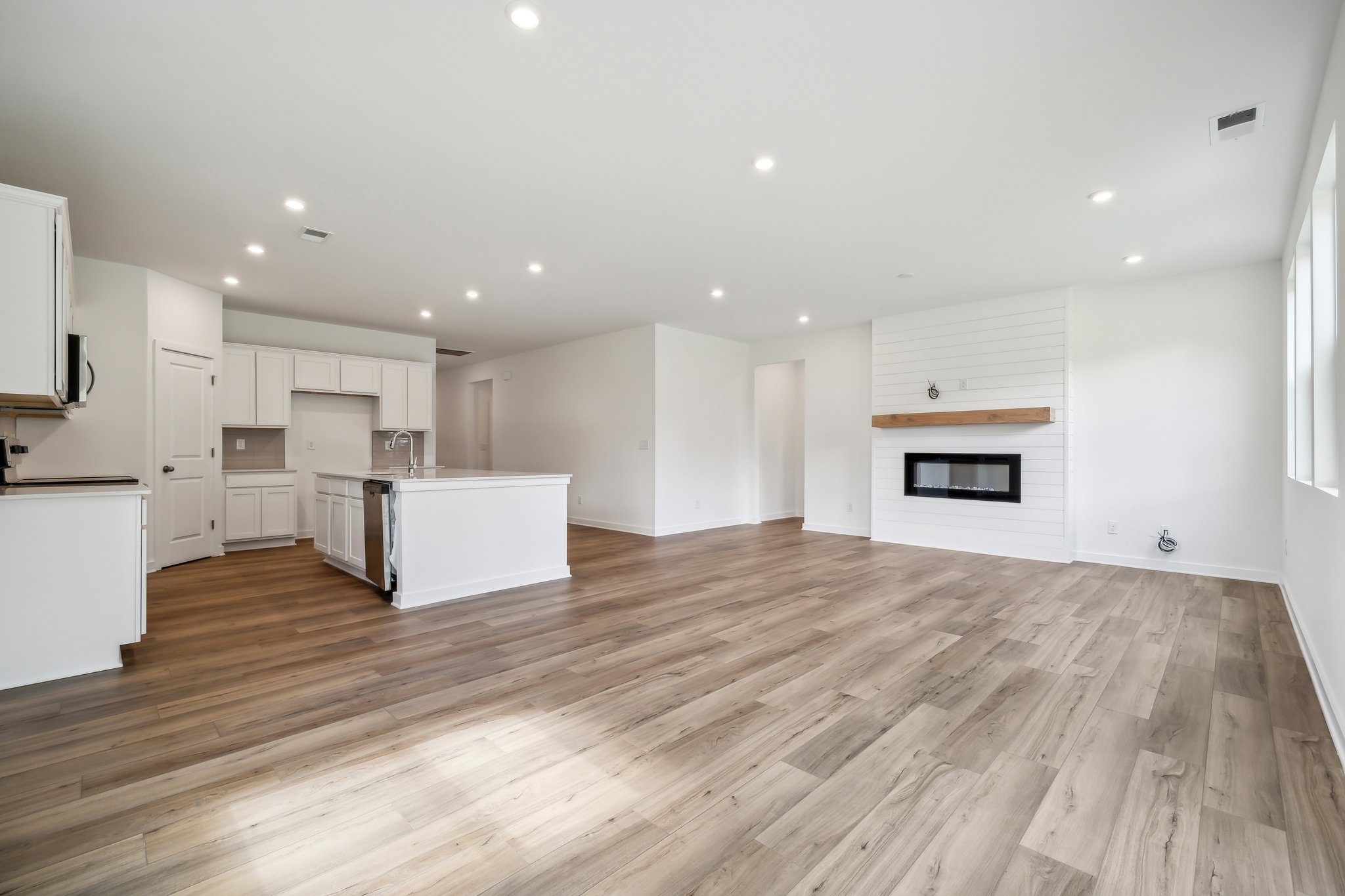 A large kitchen with white cabinets.