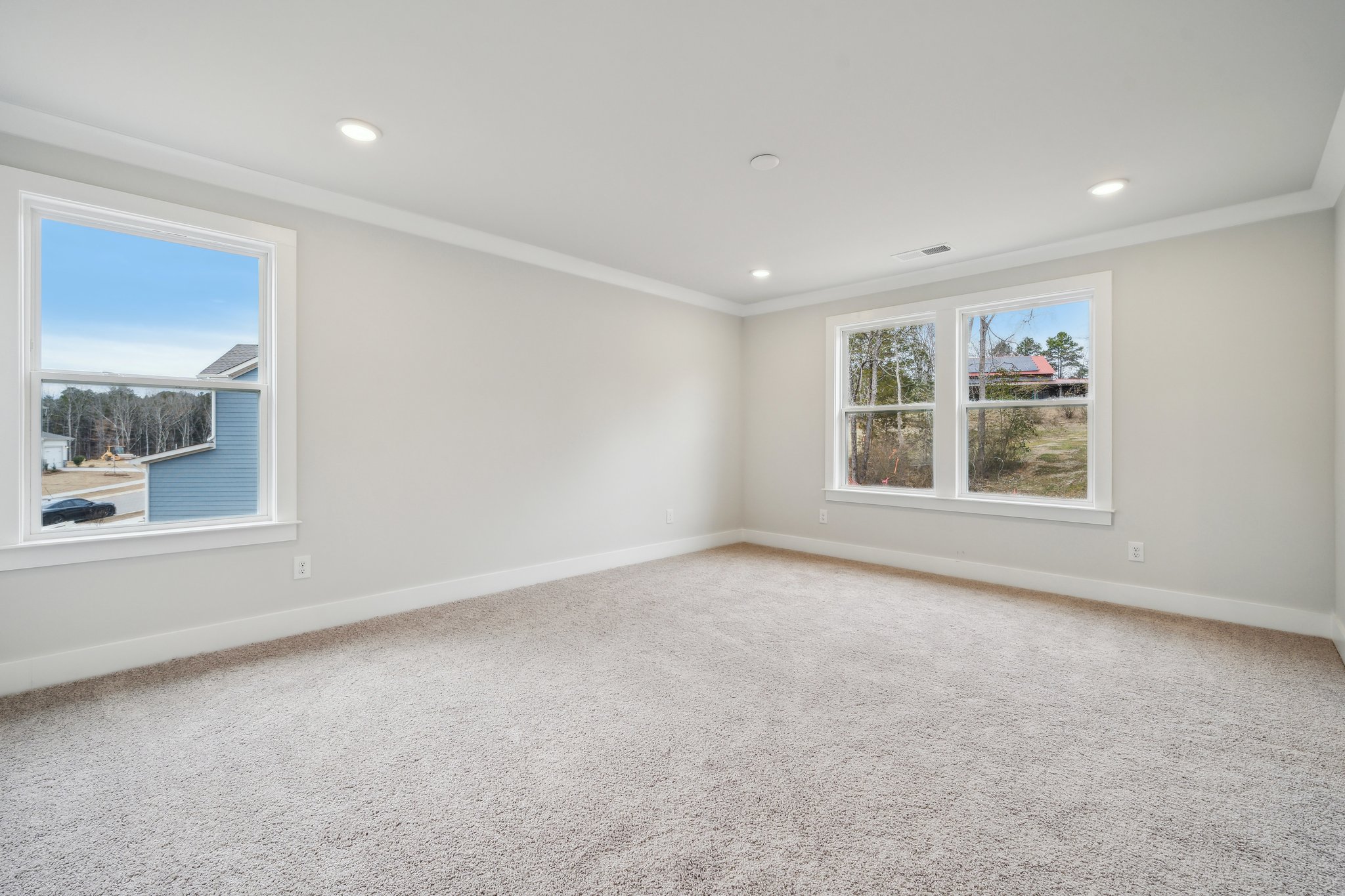 A room with a window and a carpet.