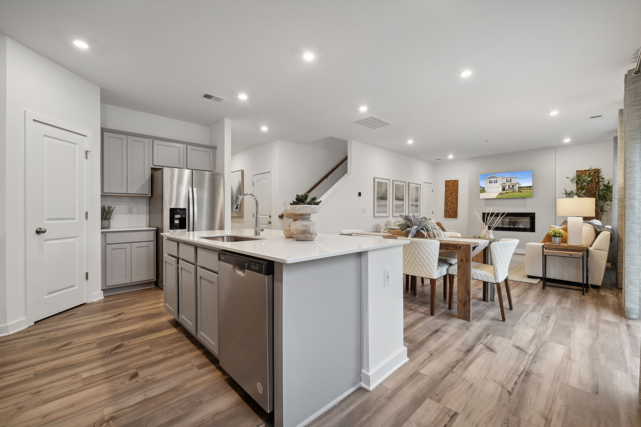 A kitchen with white cabinets.
