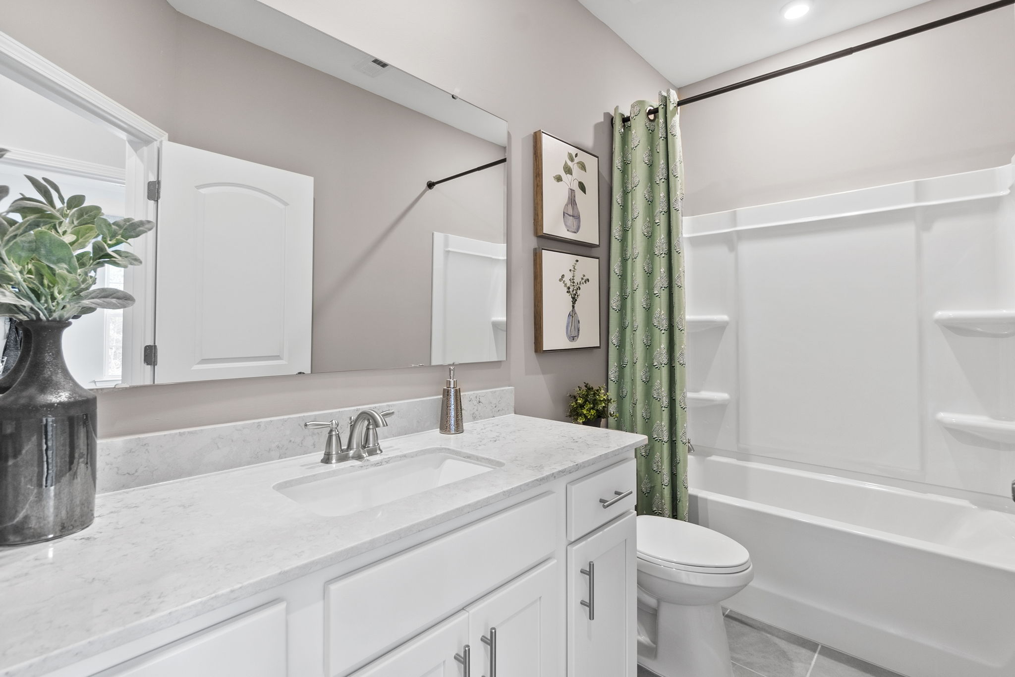 A bathroom with a sink toilet and a bathtub.