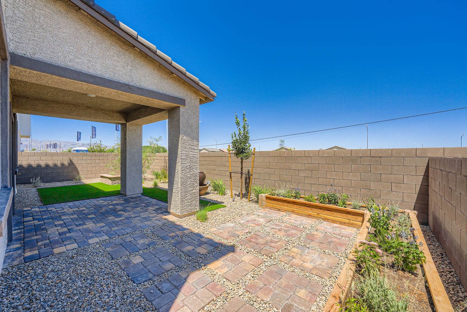 A brick patio with a brick wall and a brick walkway.