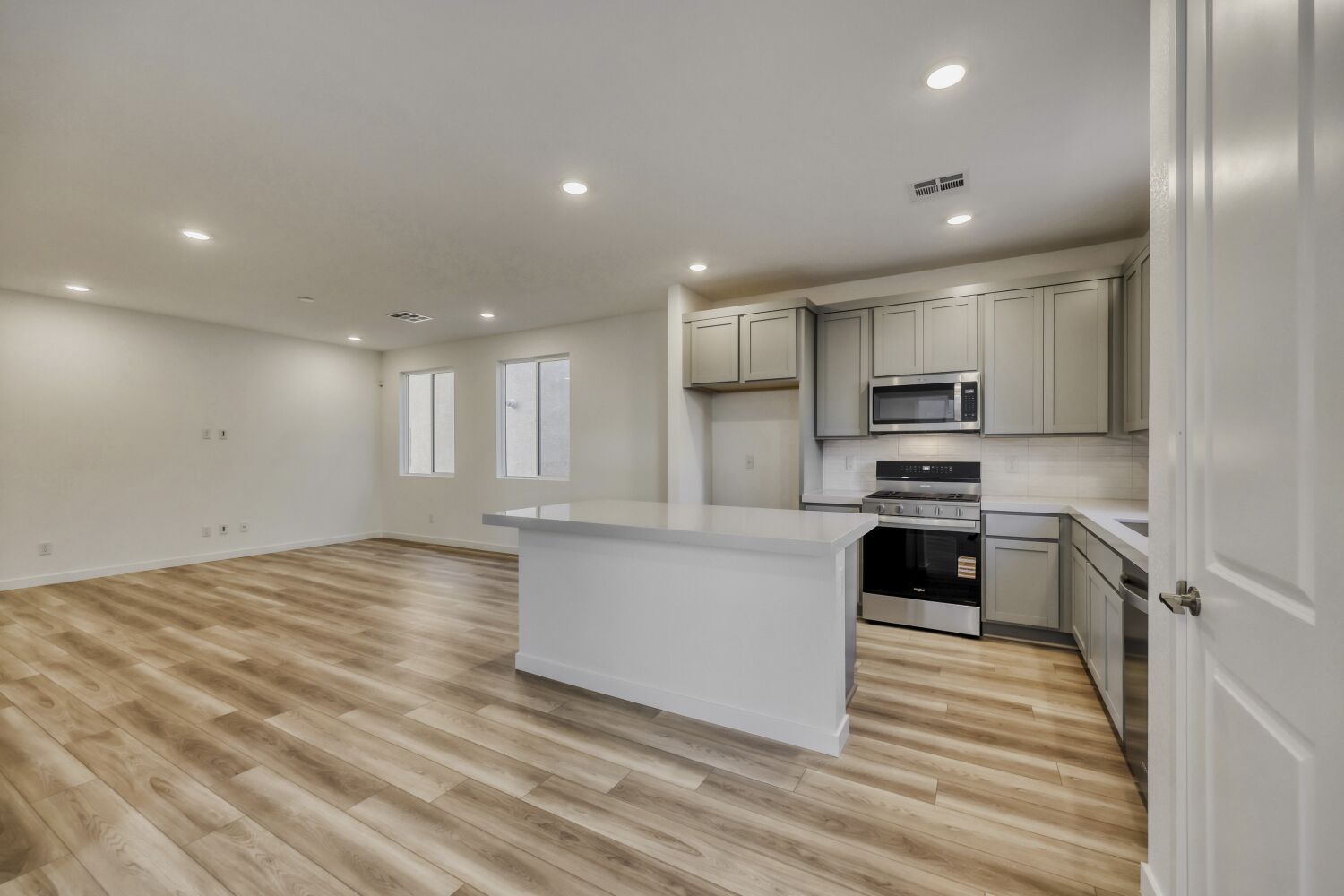A kitchen with white cabinets.