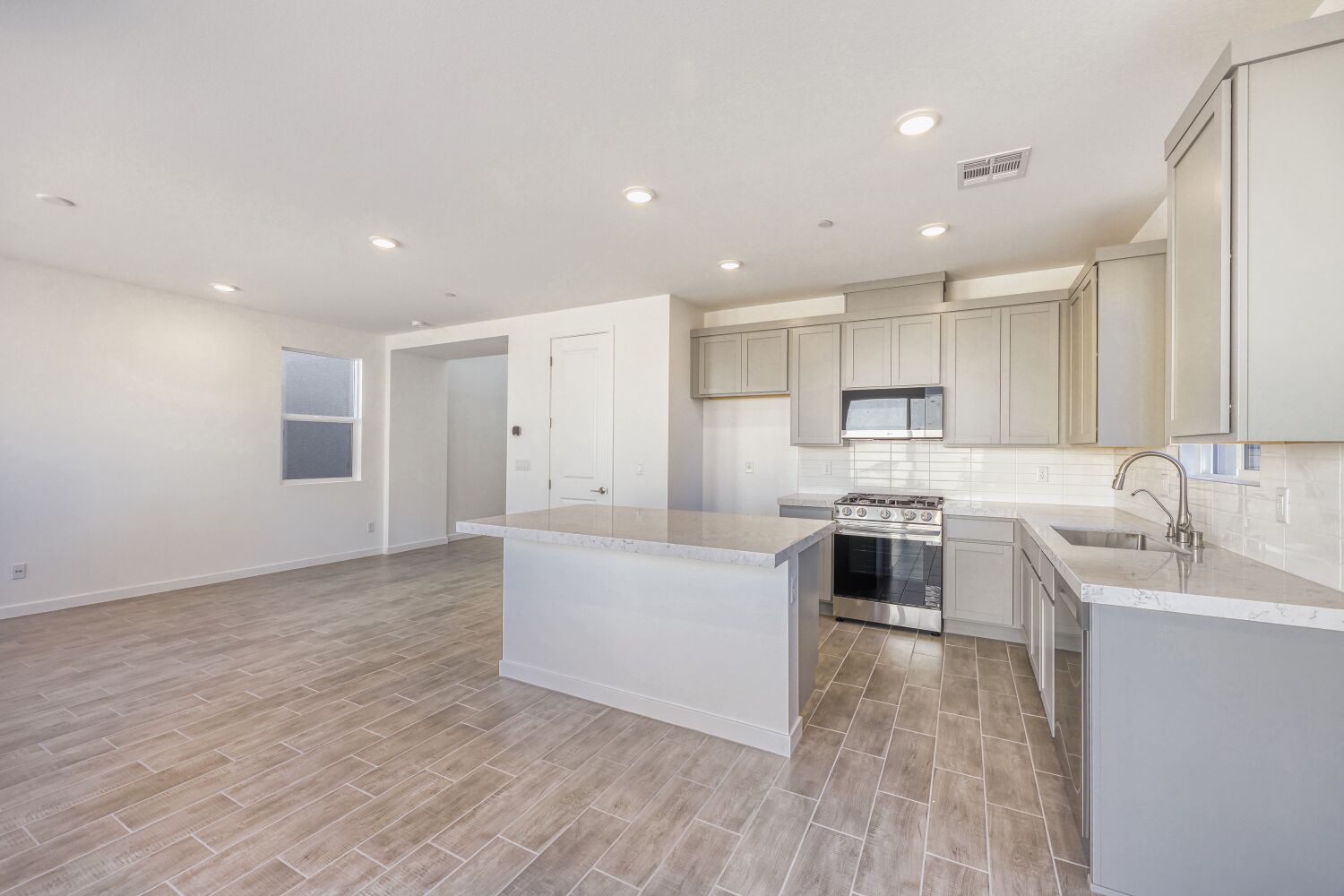 A kitchen with white cabinets.