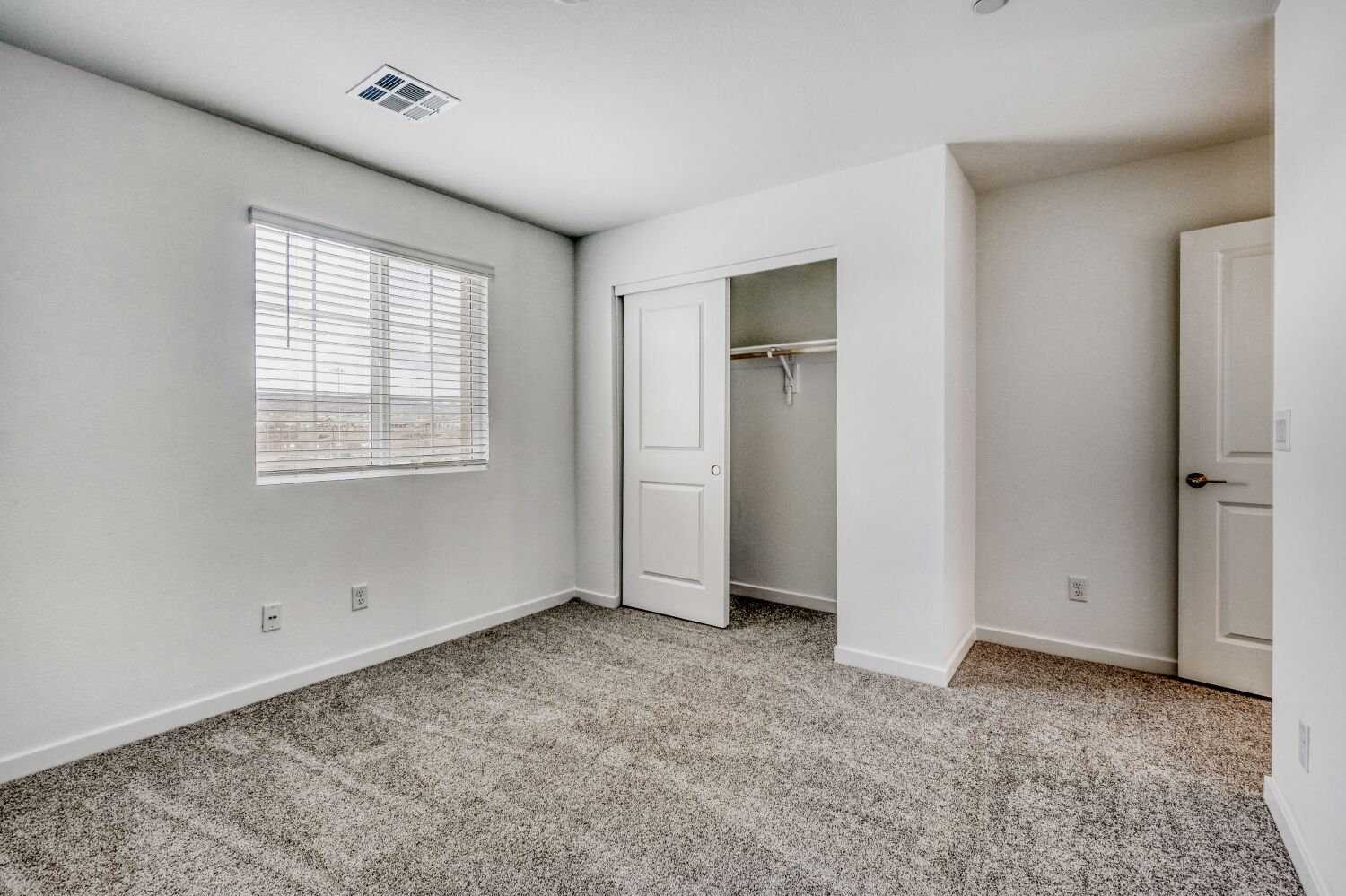 A room with white walls and a window.