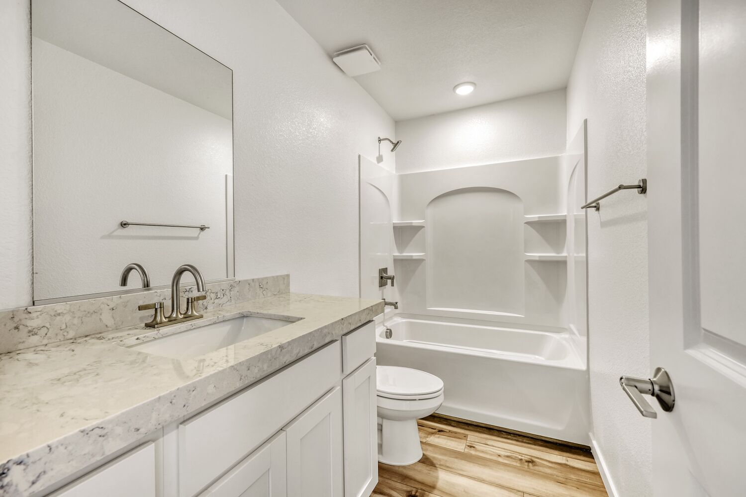 A bathroom with a tub sink and toilet.