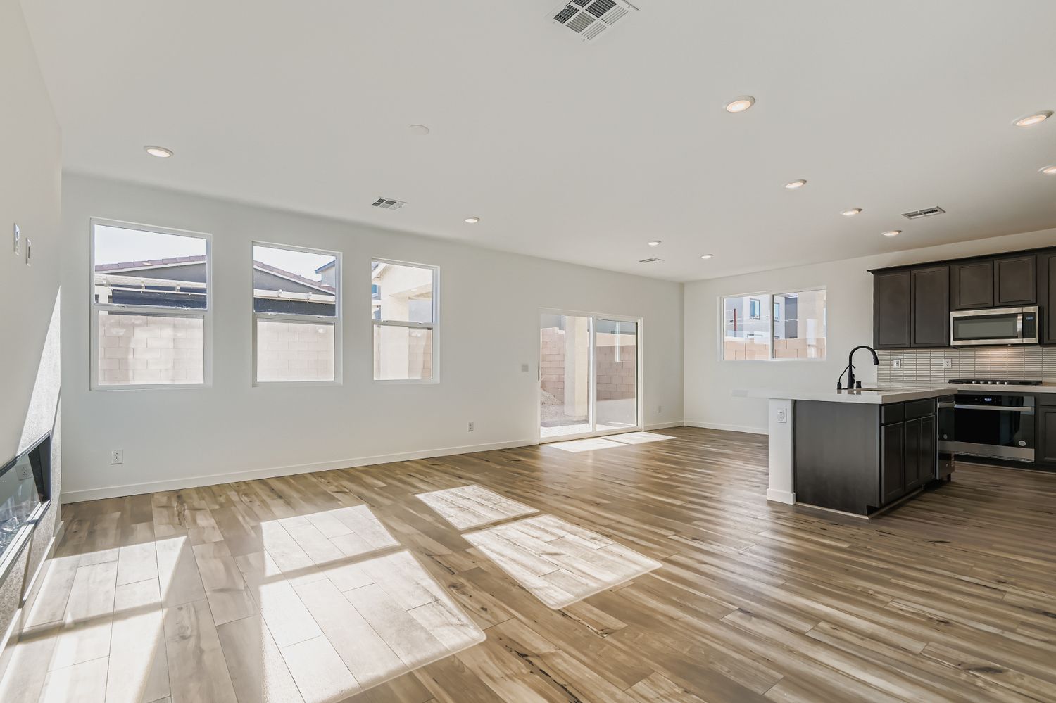 A large kitchen with a wood floor.