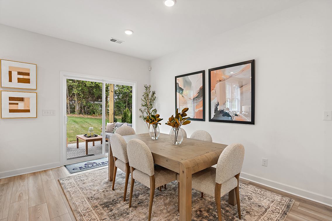 A dining room with a table and chairs.