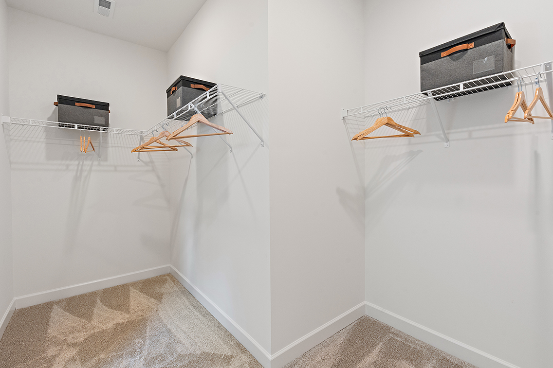 A room with a white wall and a white wall with a black box and a black box on.