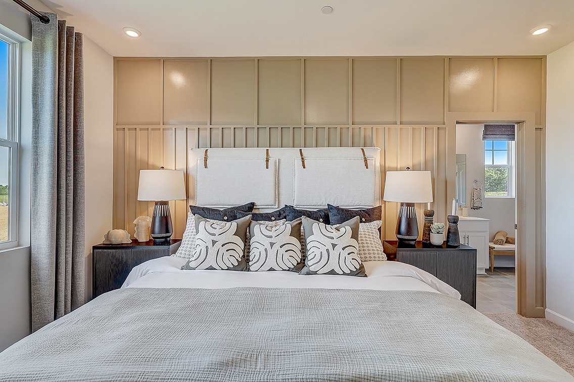 A bedroom with a bed and lamps.