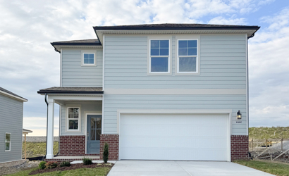 A white house with a garage.
