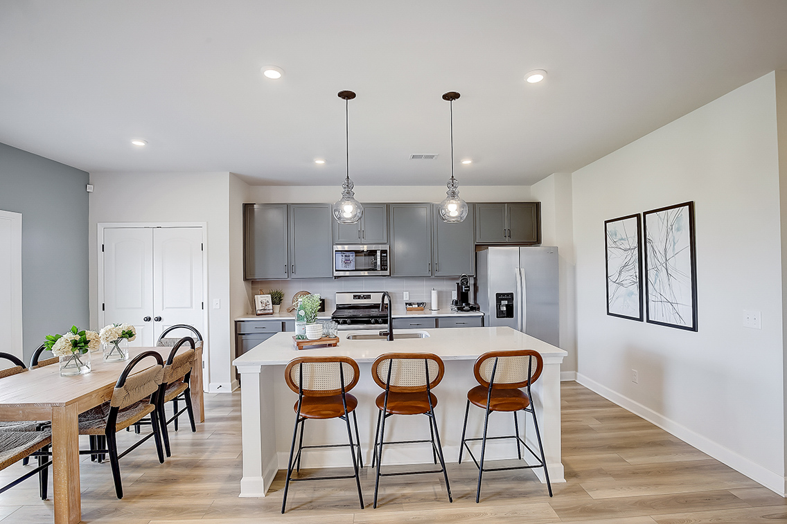 A kitchen with a dining table and a white door.