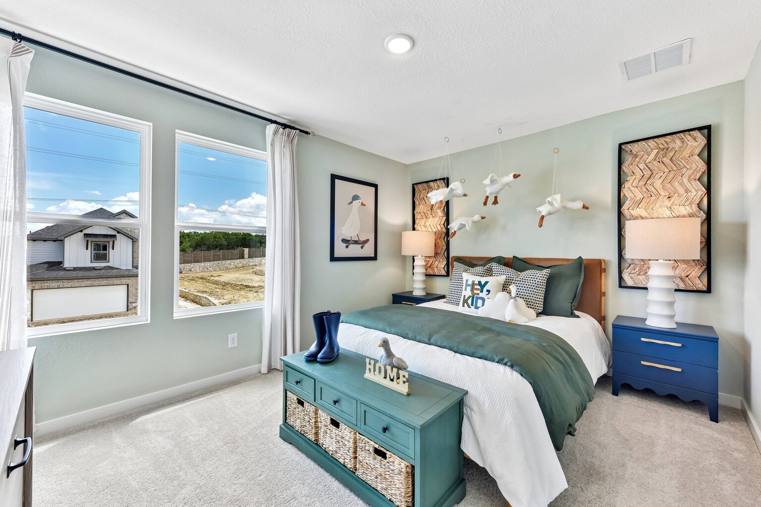 A bedroom with a blue bed.