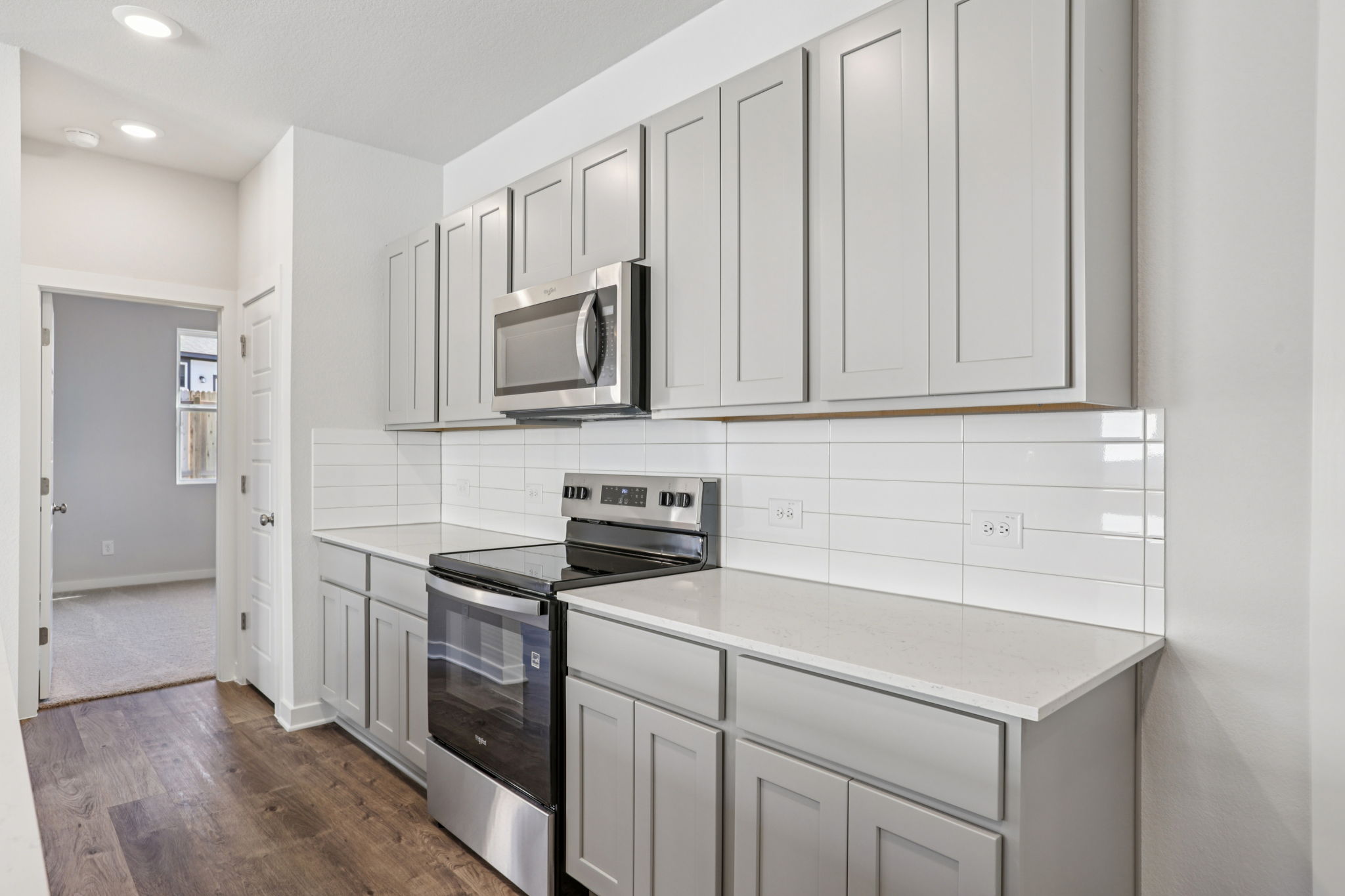 A kitchen with white cabinets.