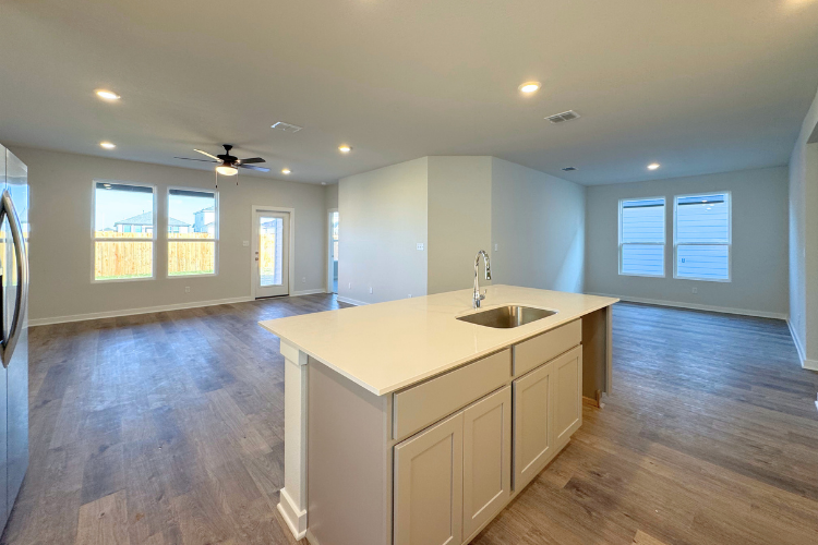 A kitchen with a sink and cabinets.