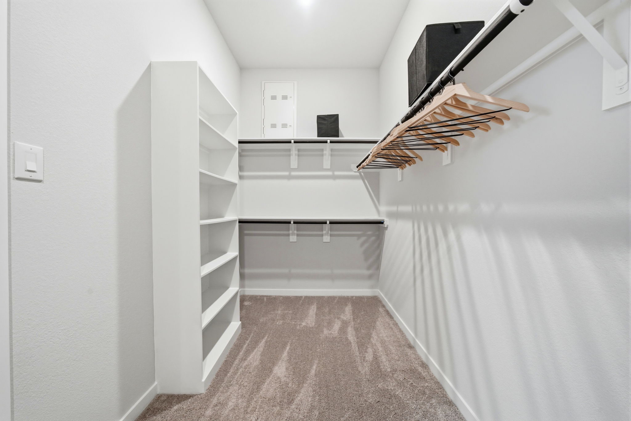 A white room with a white wall and a wood floor.