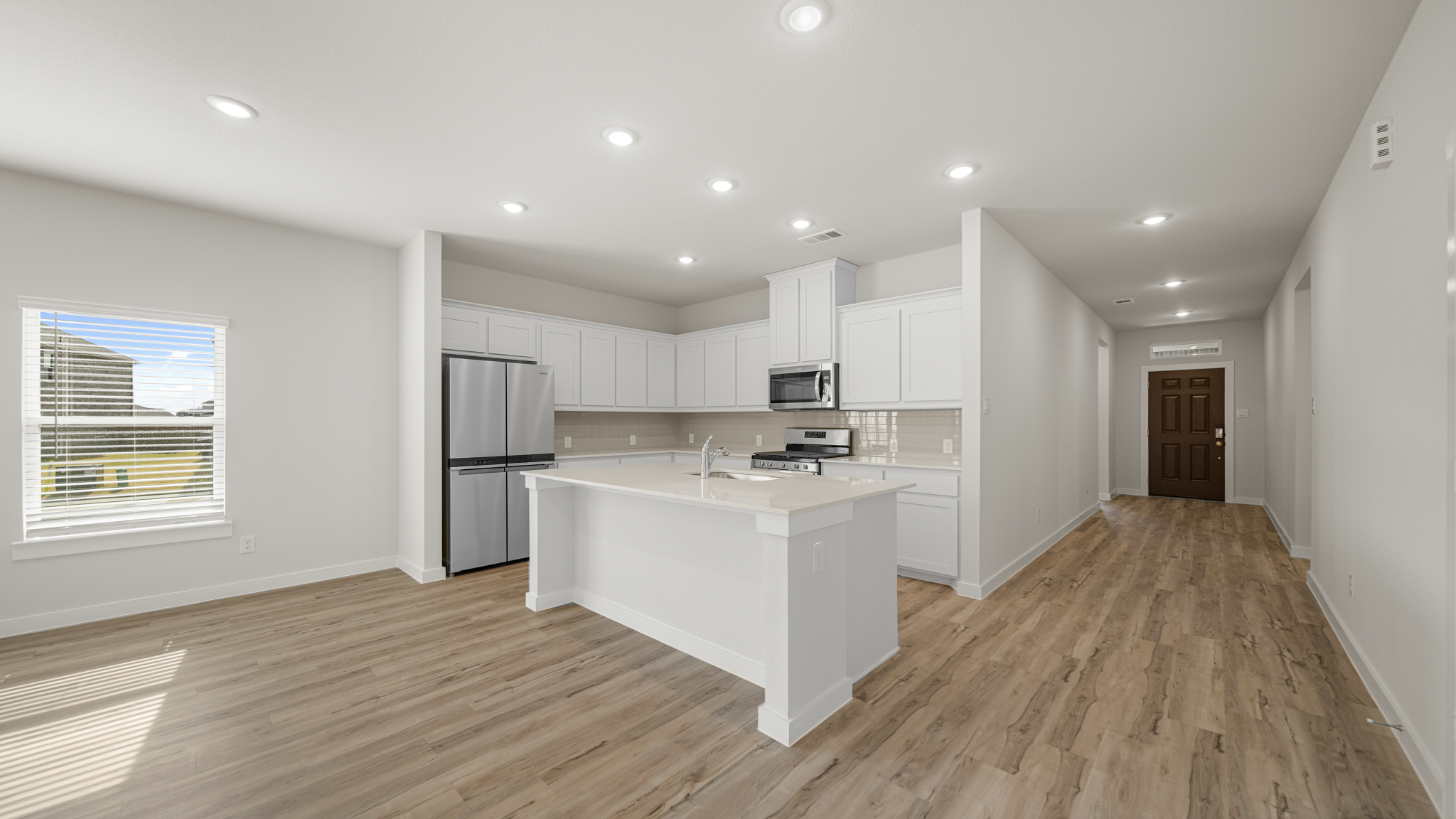 A kitchen with white cabinets.