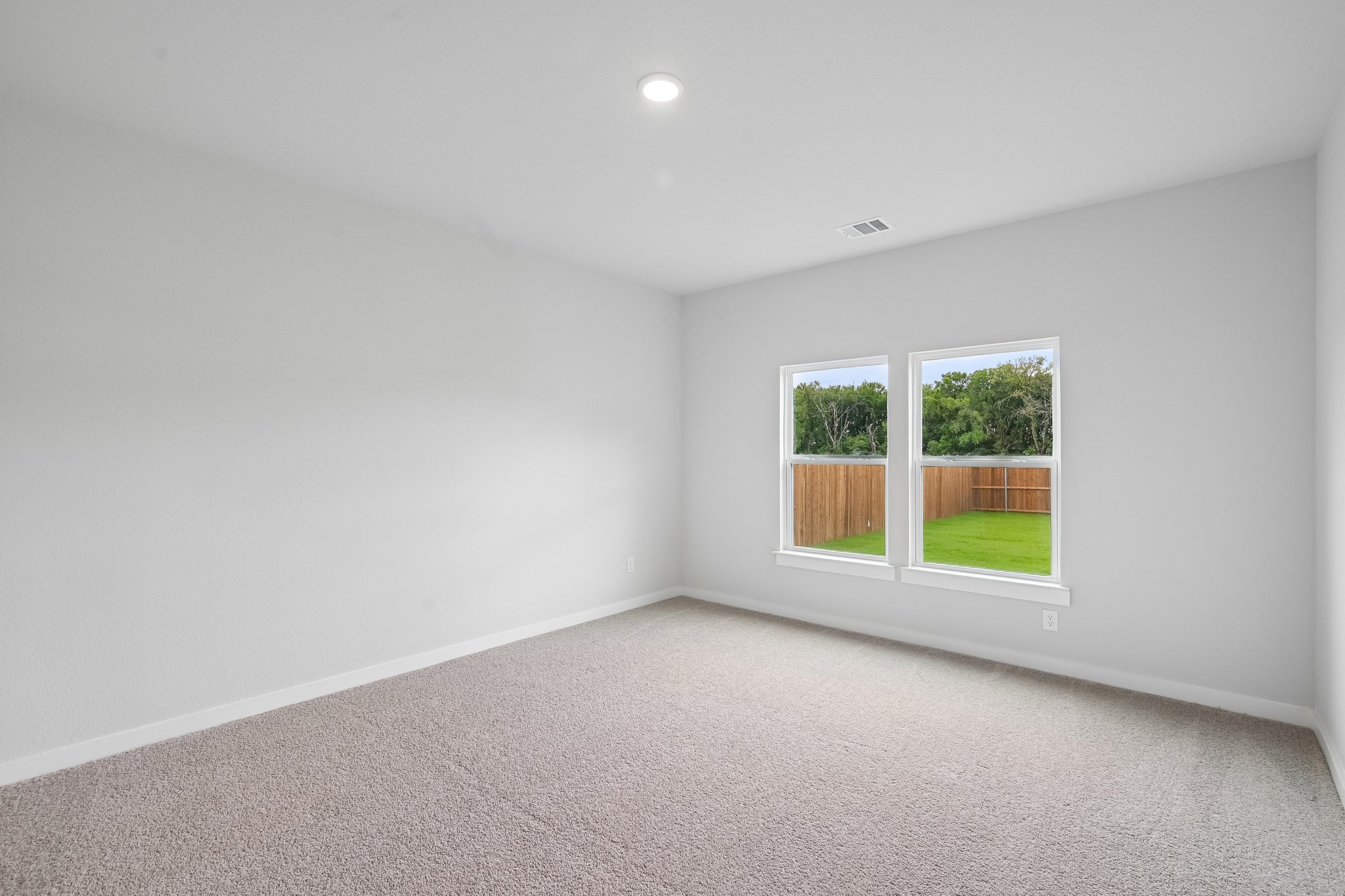 A room with a window and a carpet.