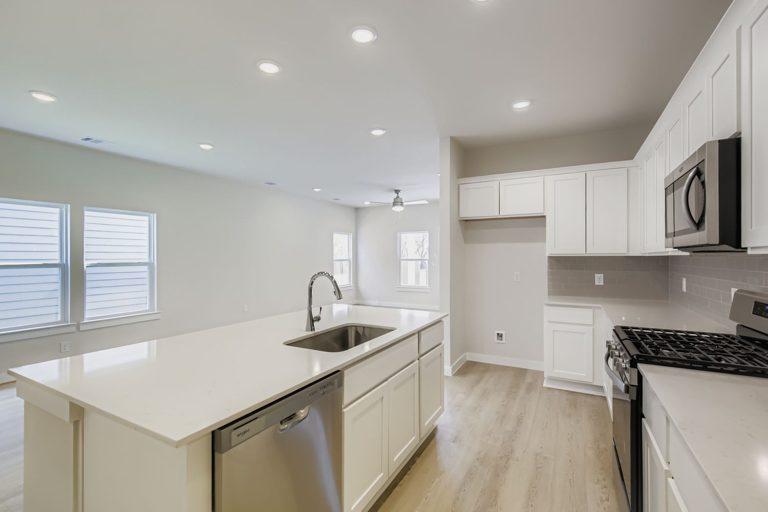 A kitchen with white cabinets.