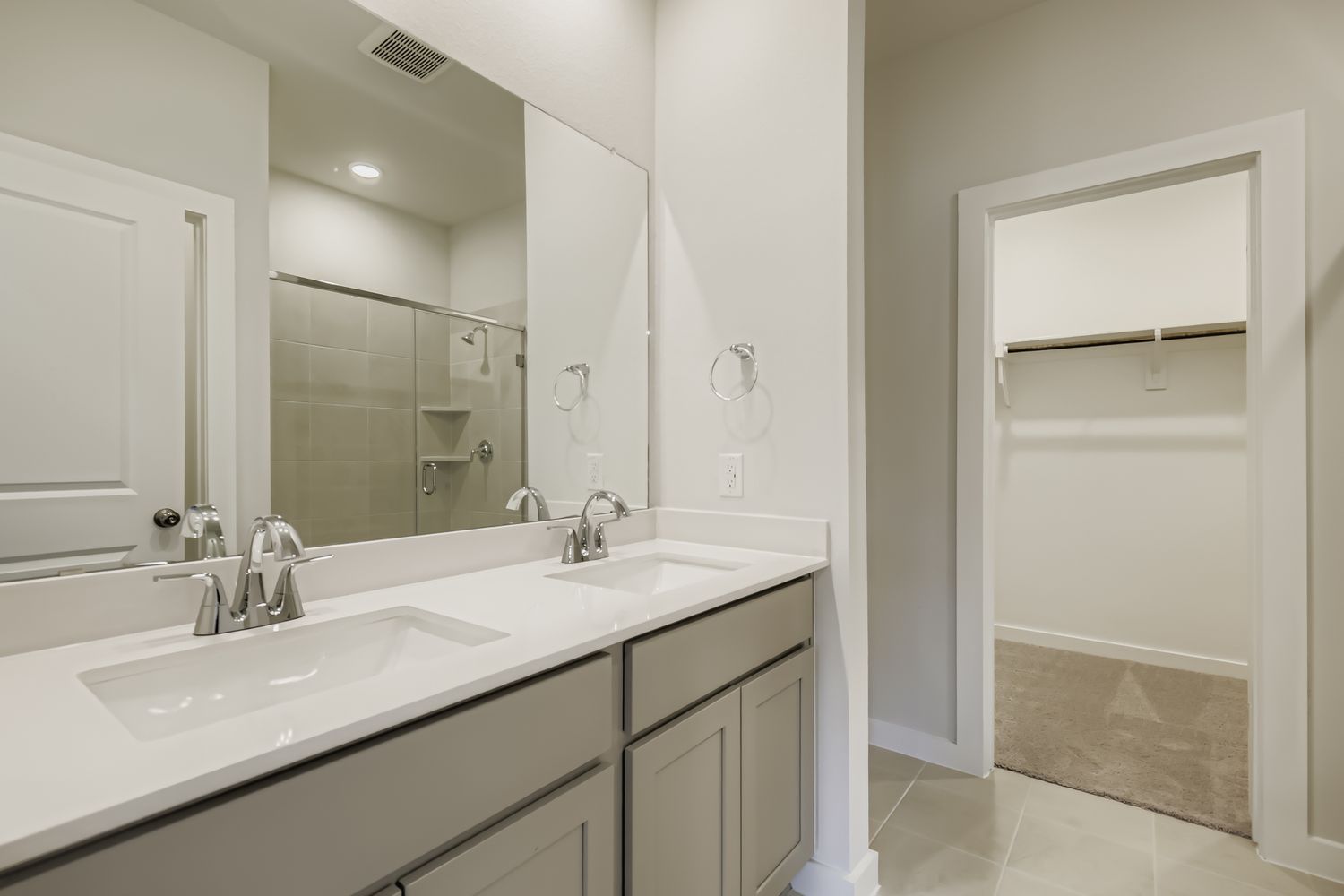 A bathroom with a large mirror.