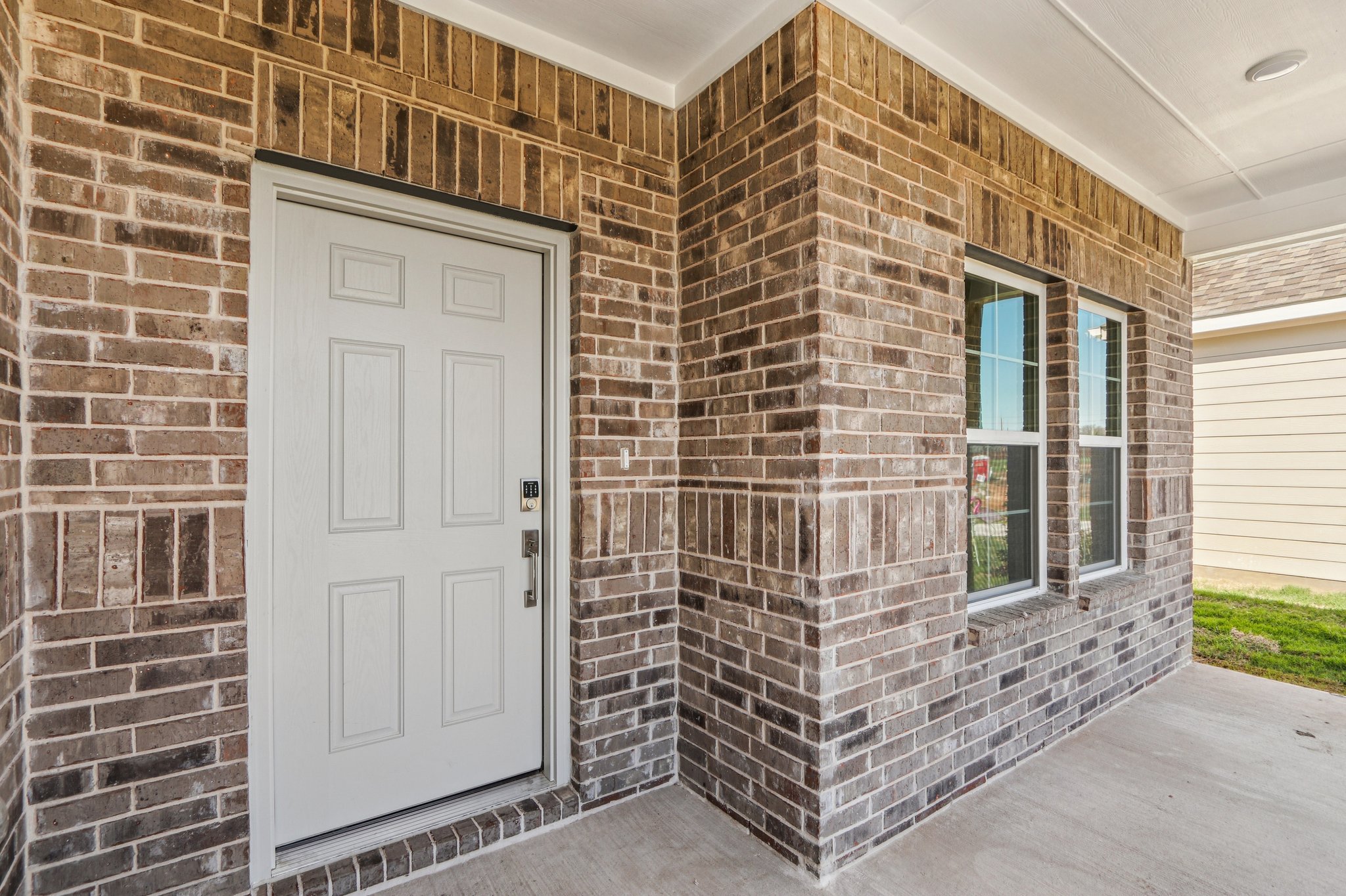 A brick building with a white door.