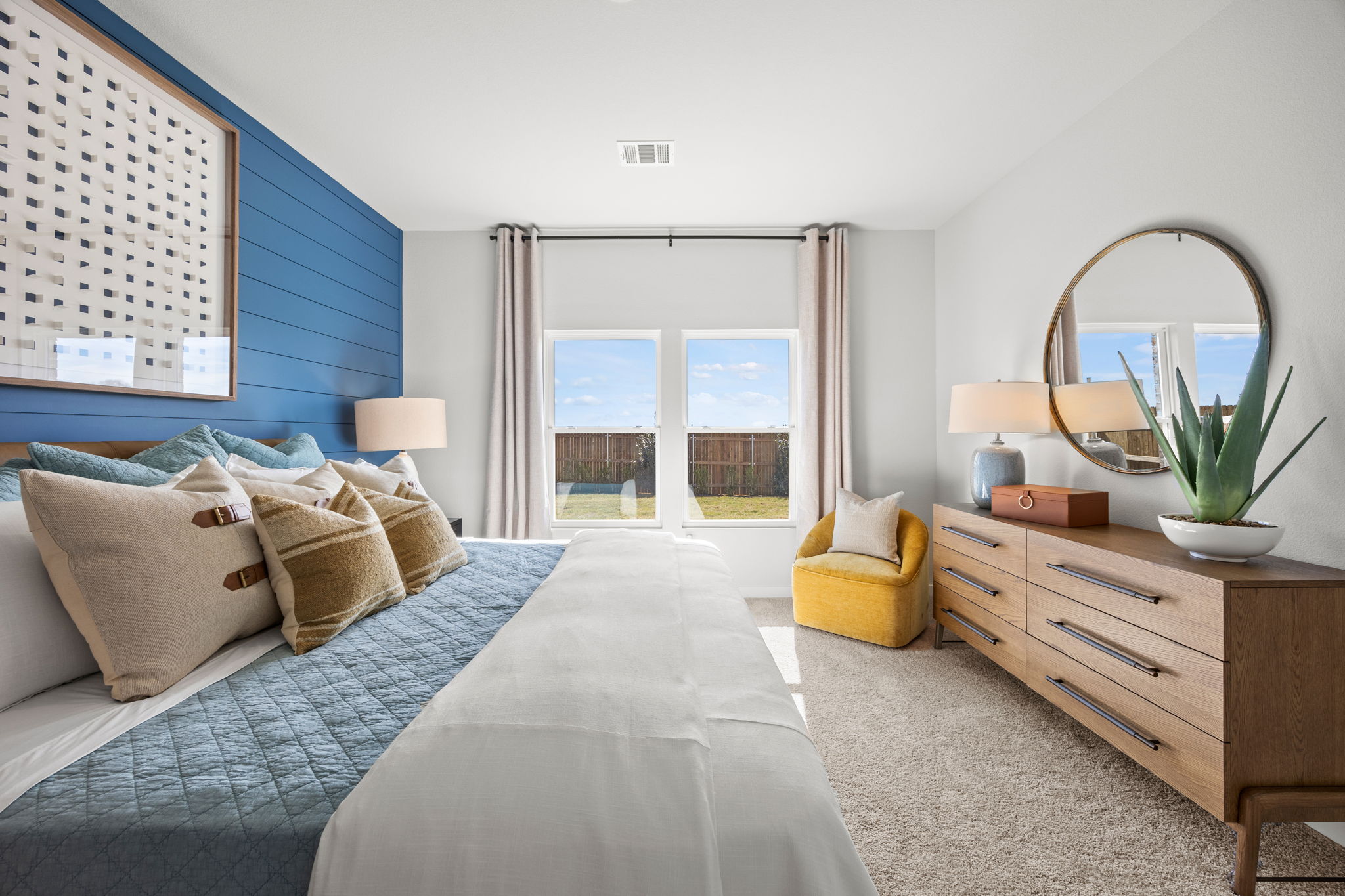 A bedroom with a large window.