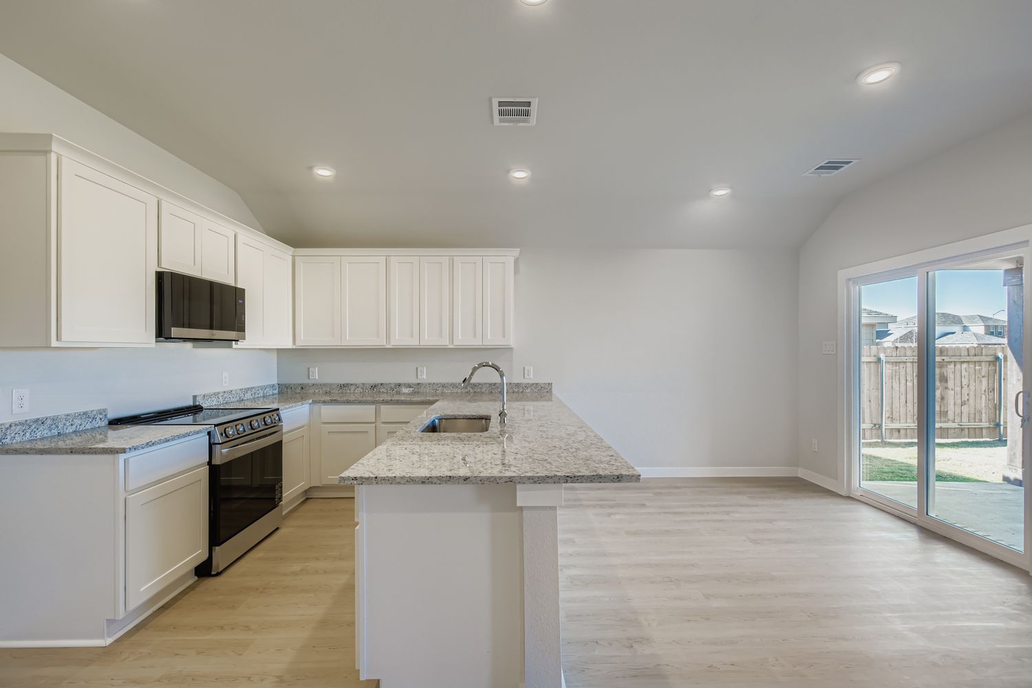 A kitchen with white cabinets.