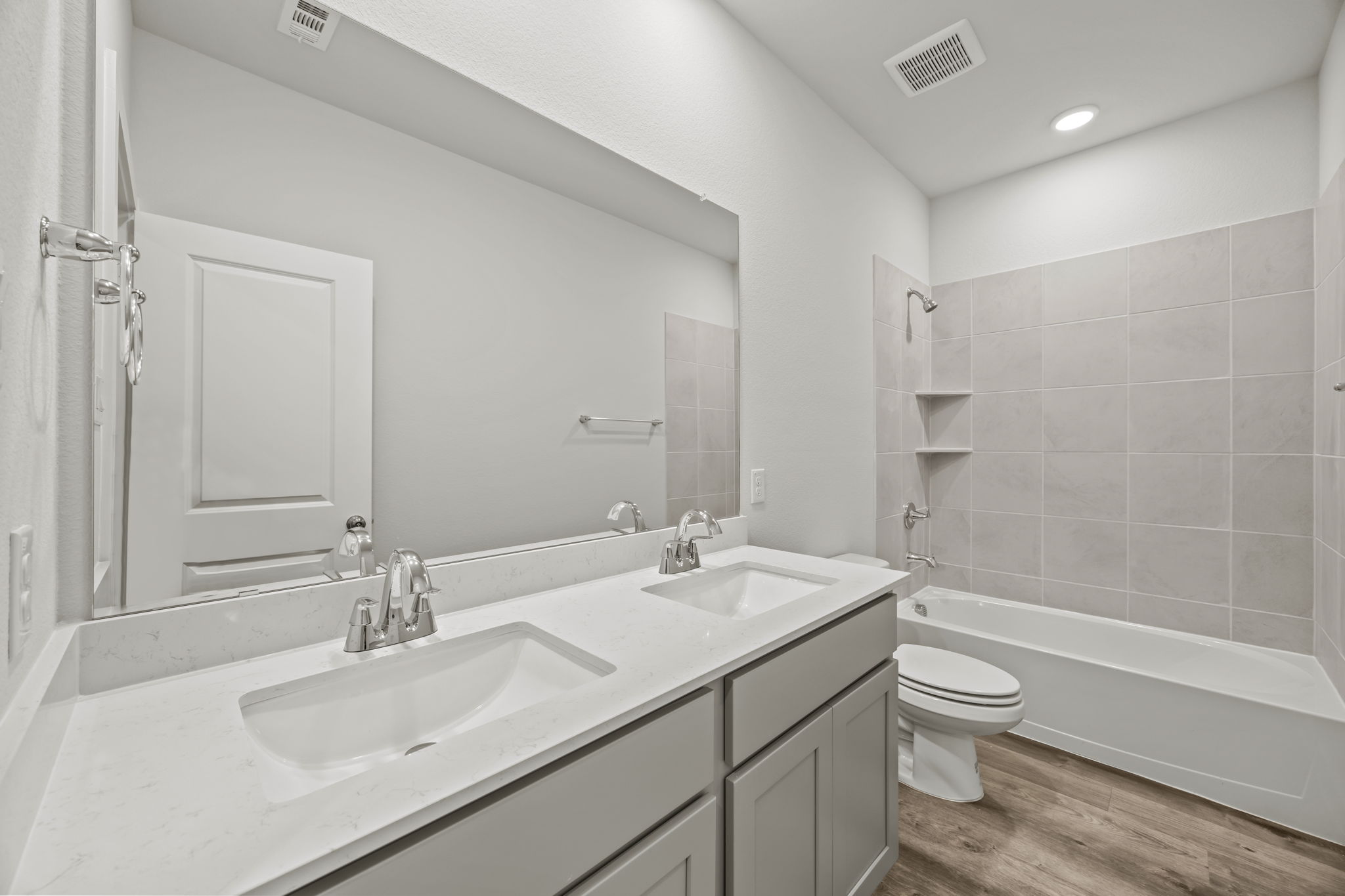 A bathroom with a tub sink and toilet.