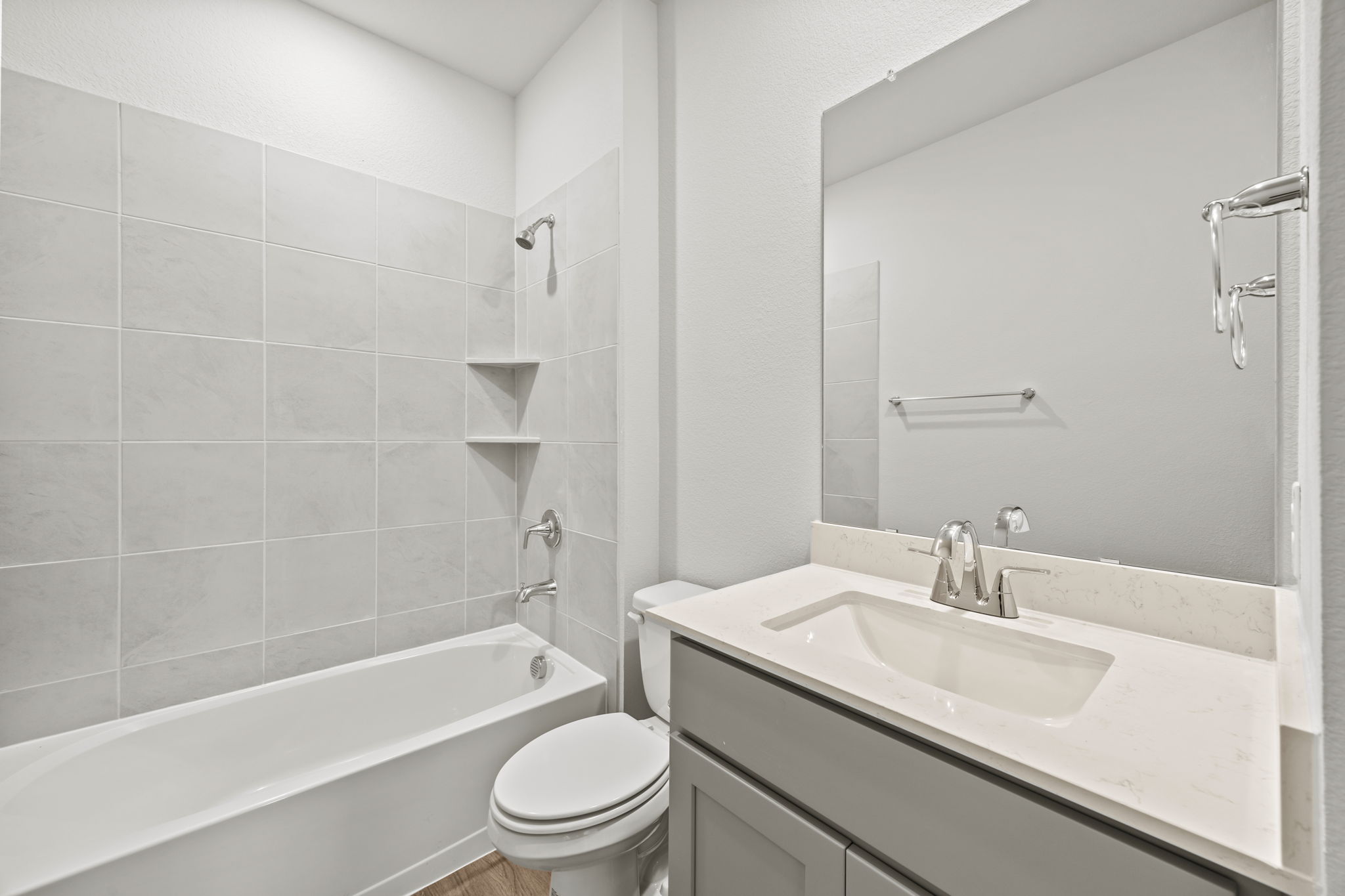 A bathroom with a tub sink and toilet.