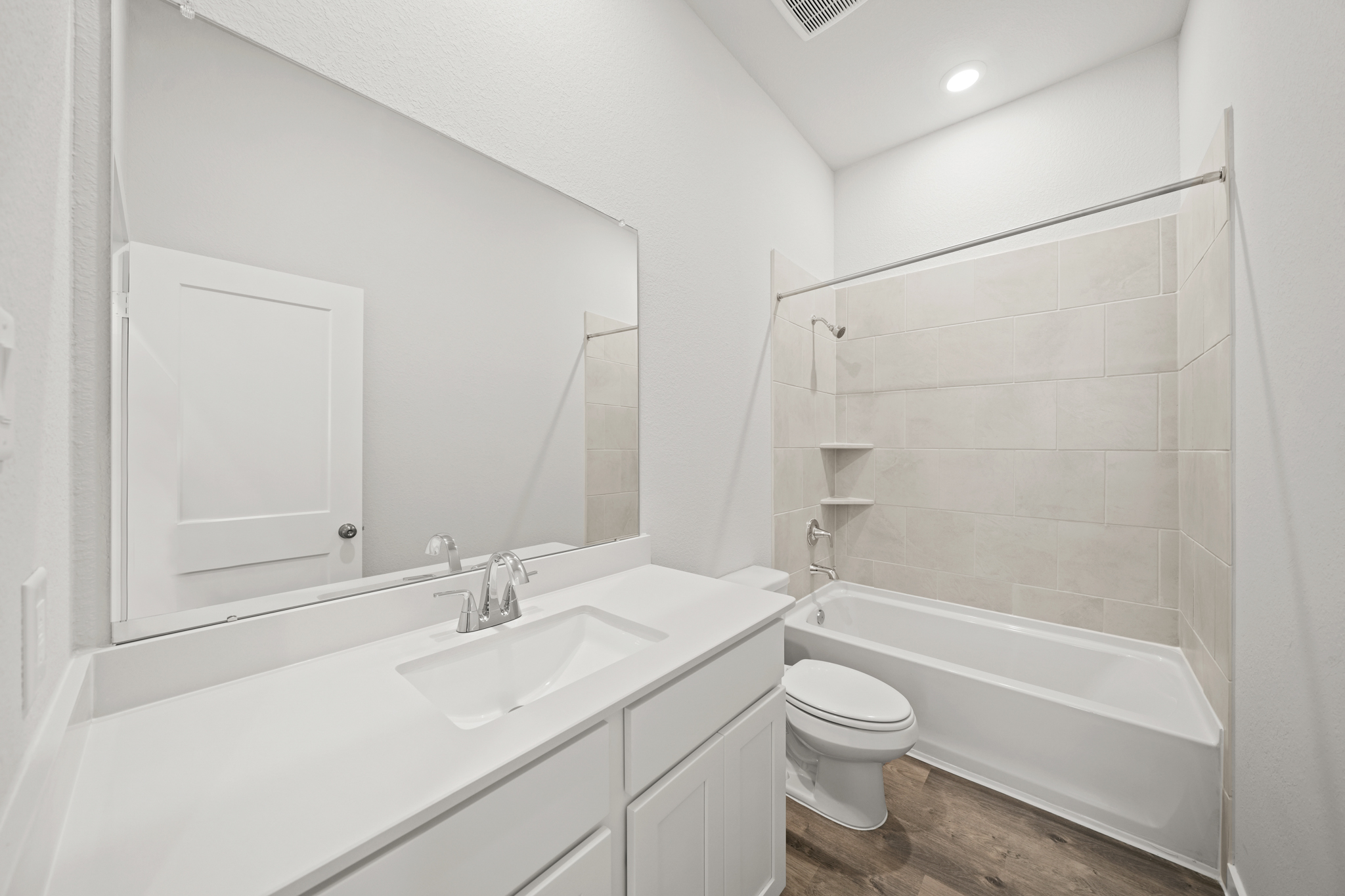 A bathroom with a tub sink and toilet.