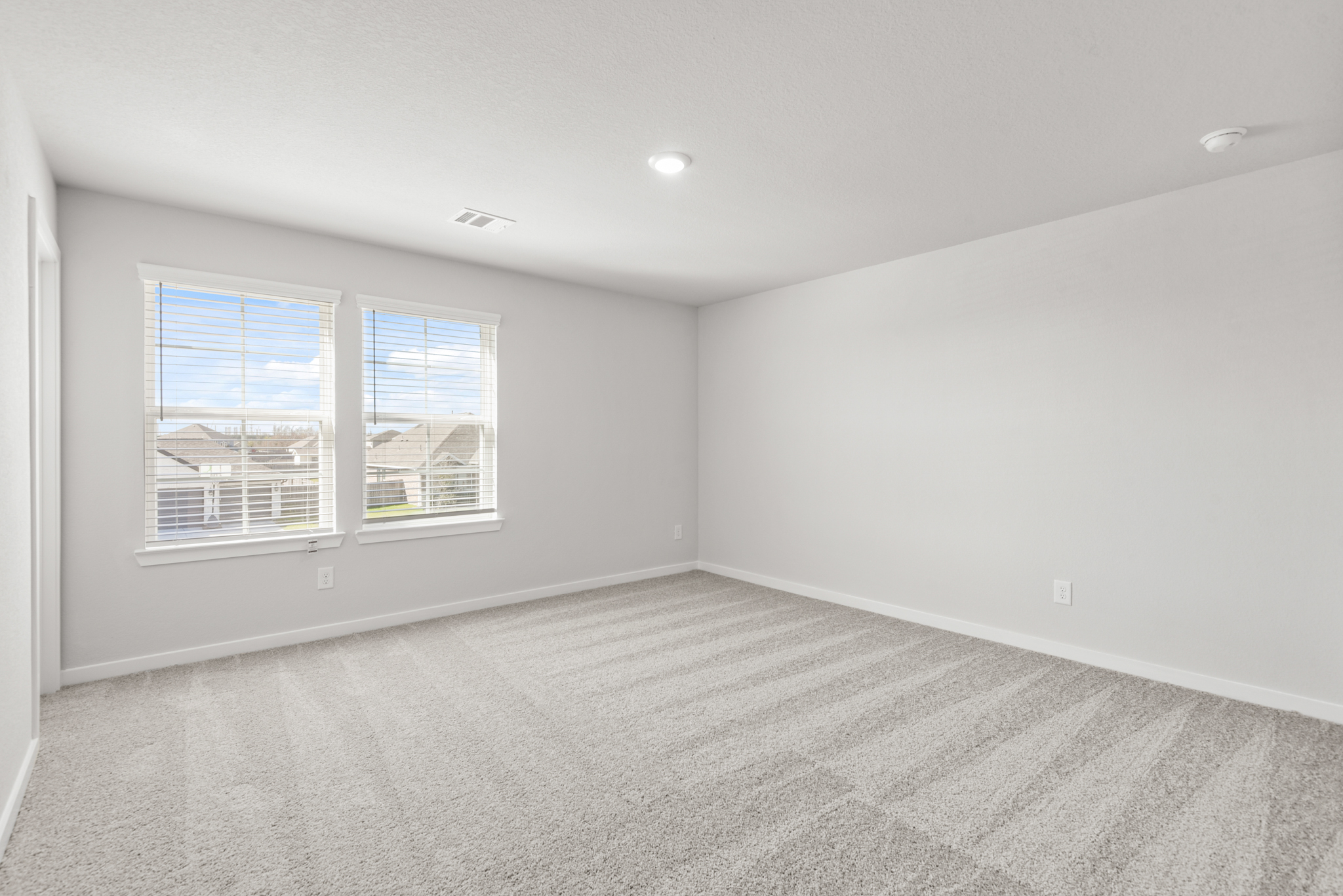 A room with a window and a carpet.