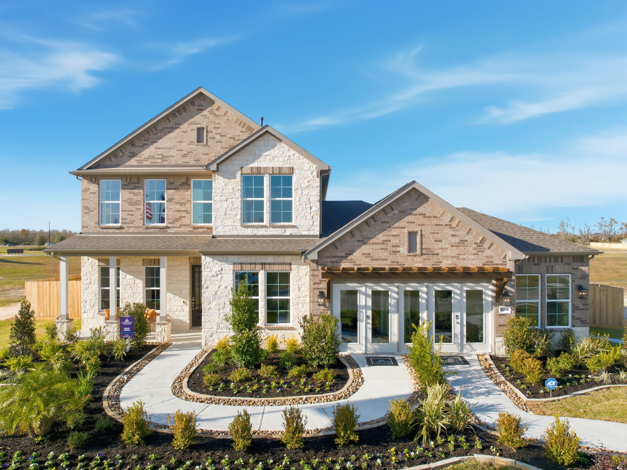 A large house with a fountain in the front.