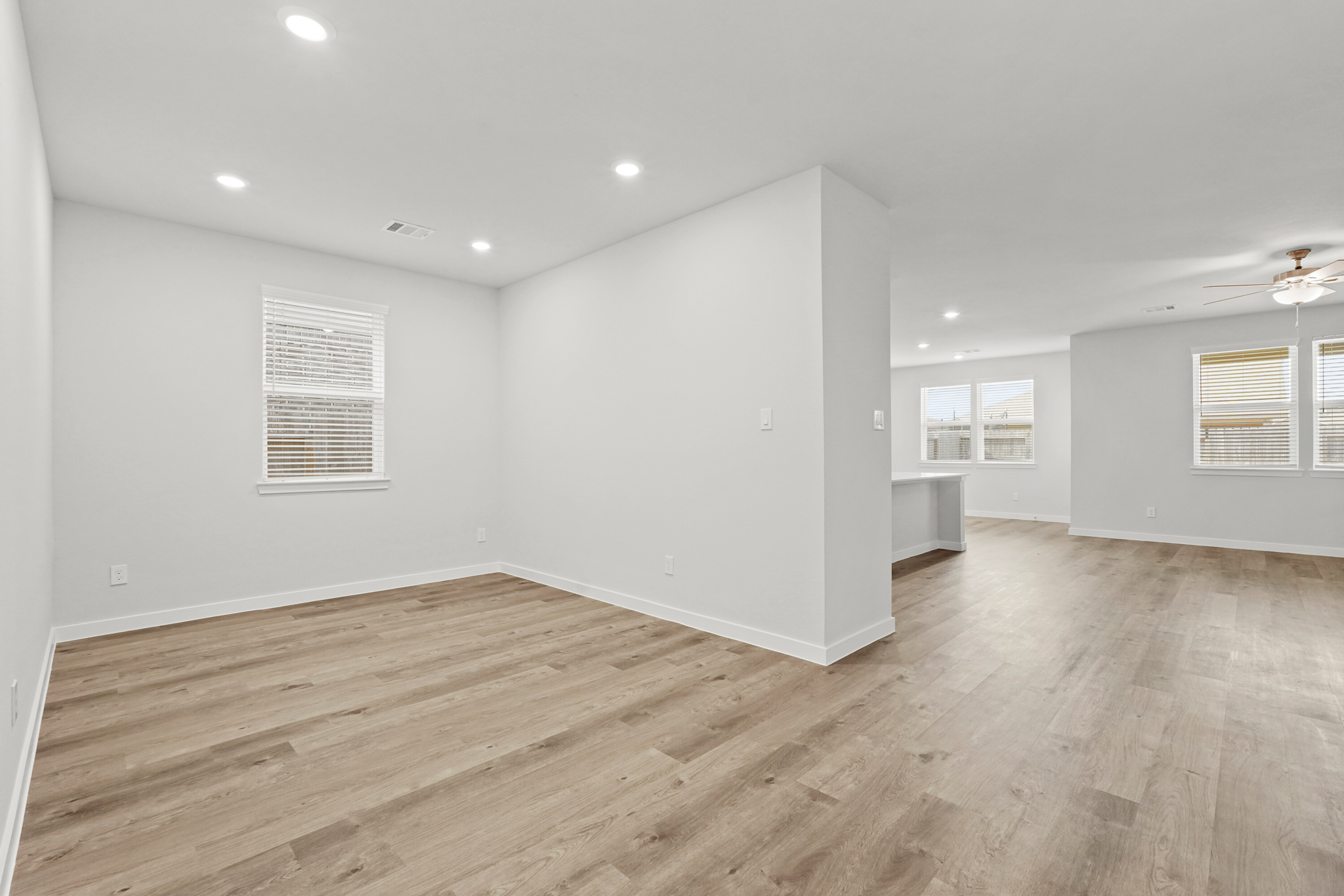 A room with a wood floor and white walls.