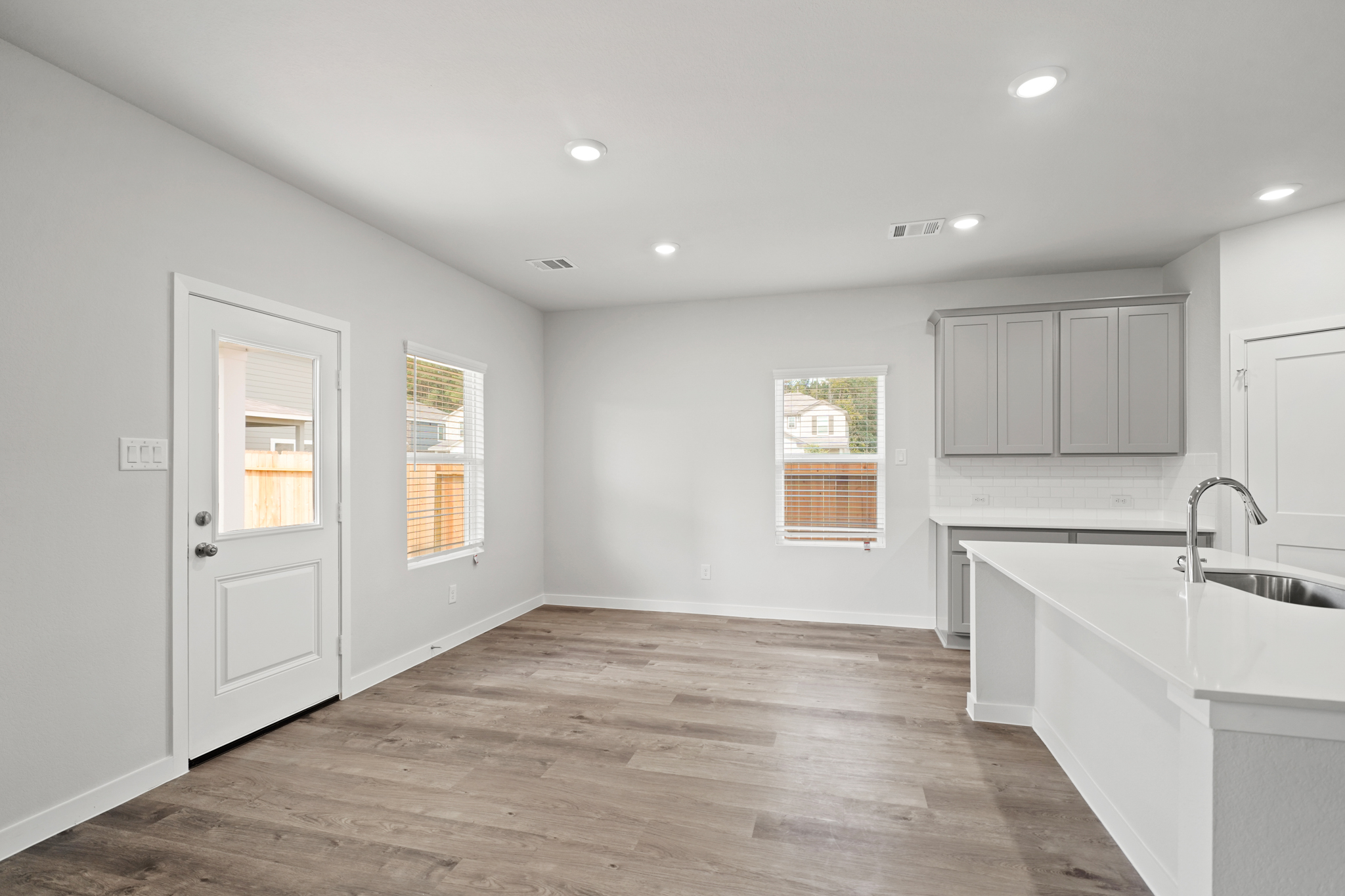 A bathroom with white cabinets.