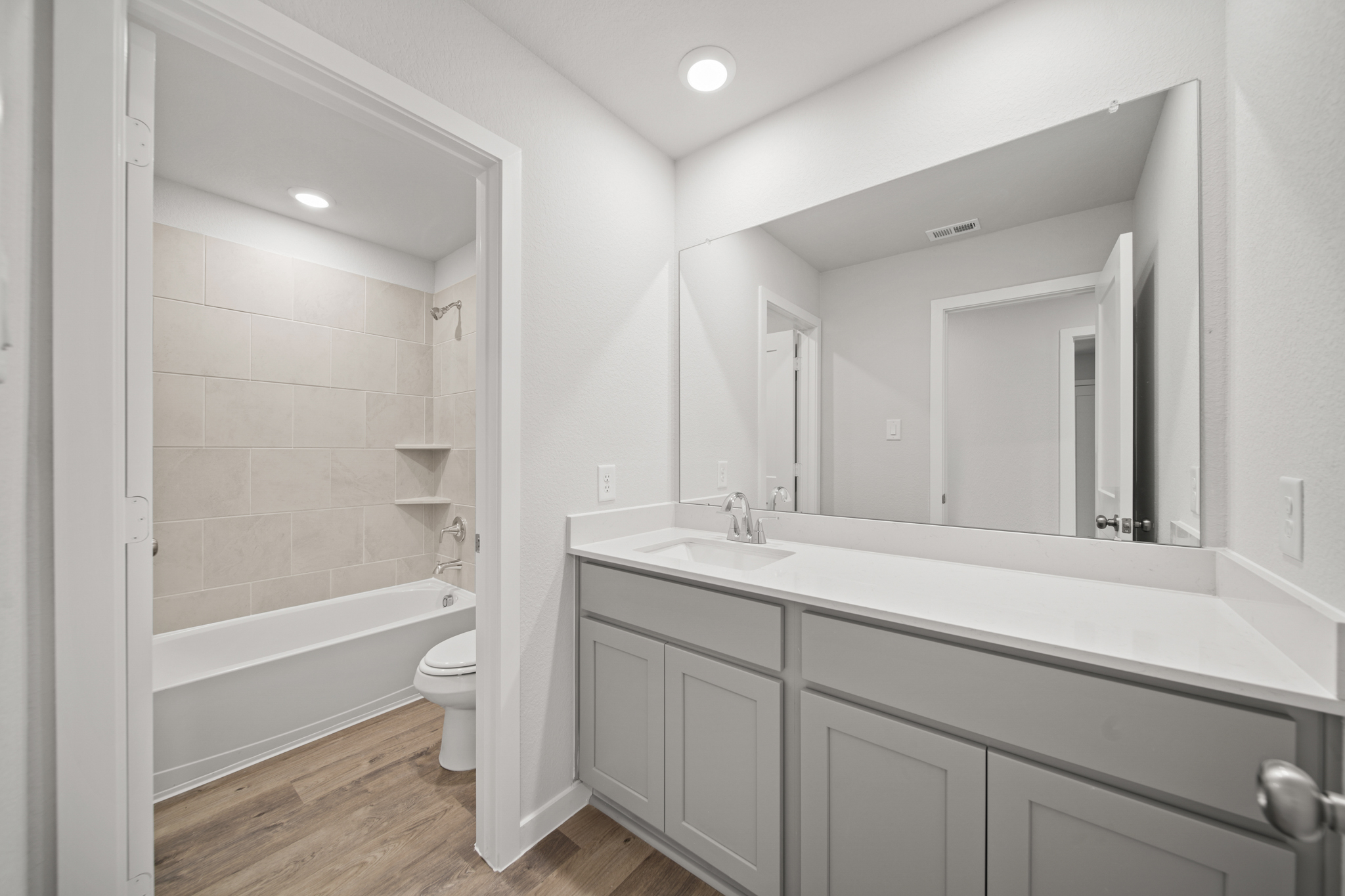 A bathroom with a tub sink and toilet.