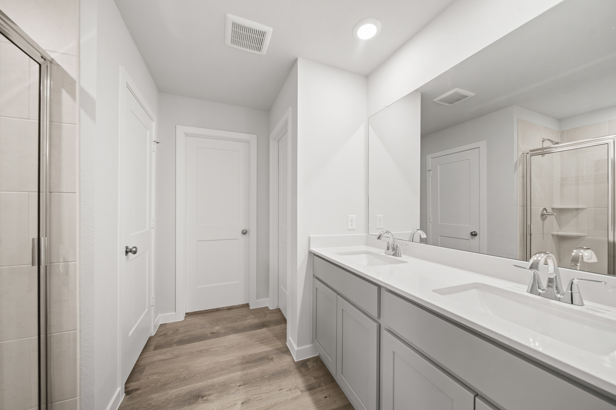 A bathroom with a large mirror.