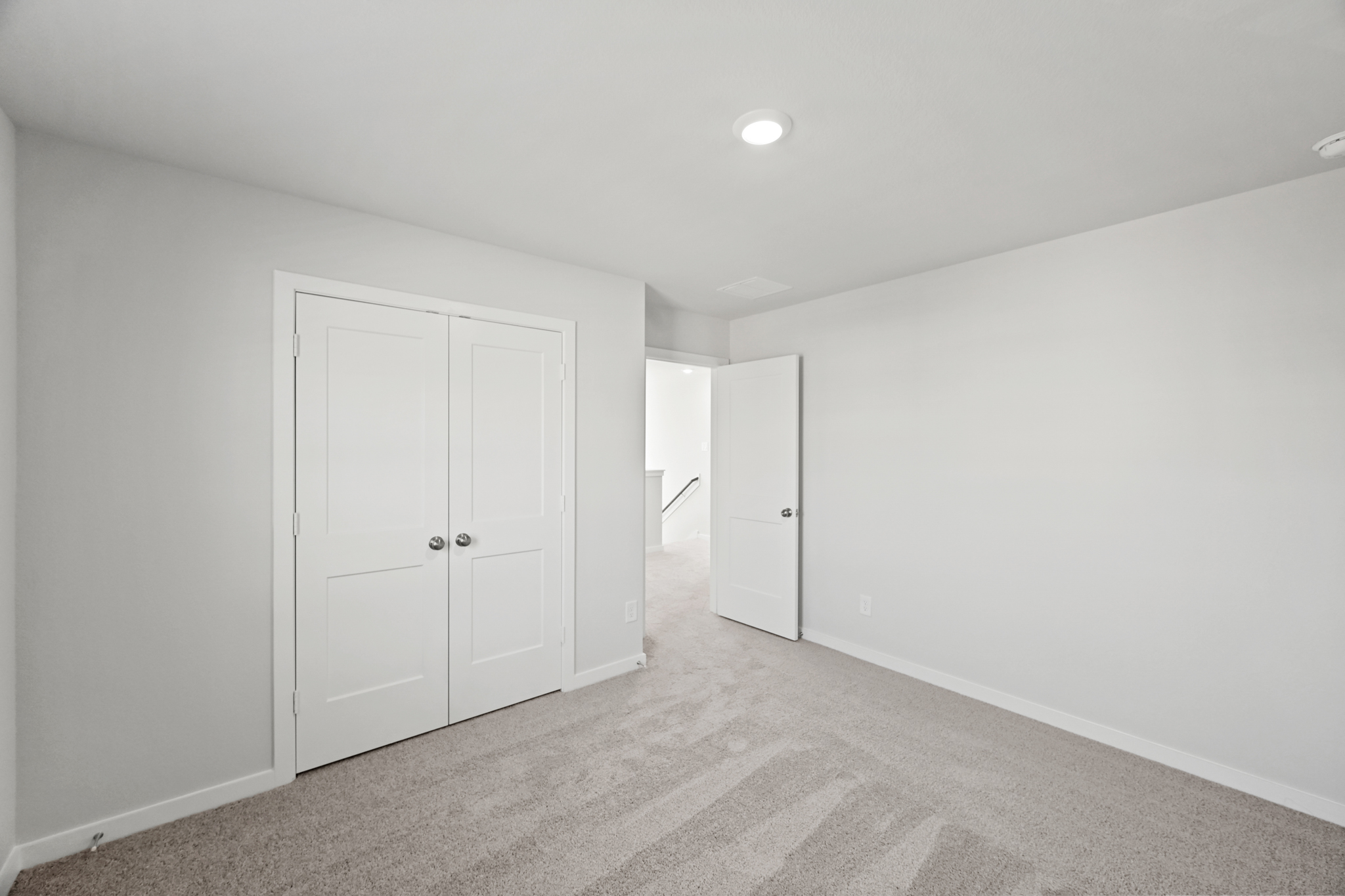 A hallway with white doors.