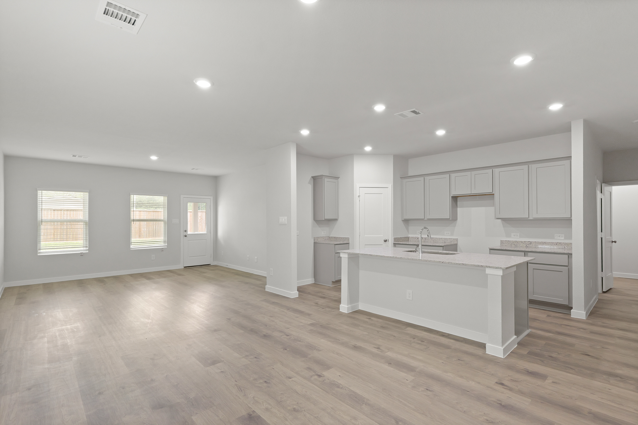 A large kitchen with white cabinets.