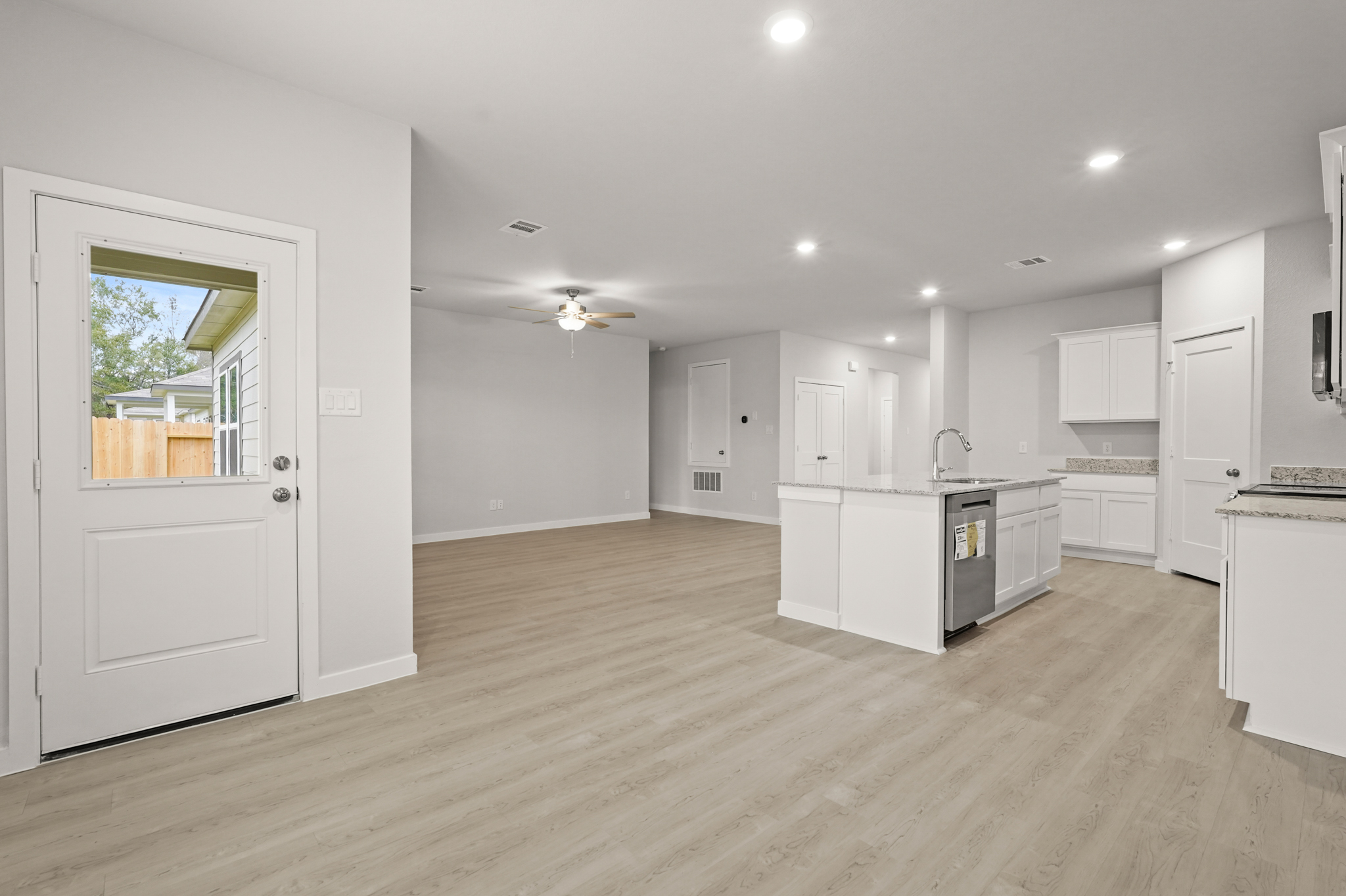 A kitchen with white cabinets.