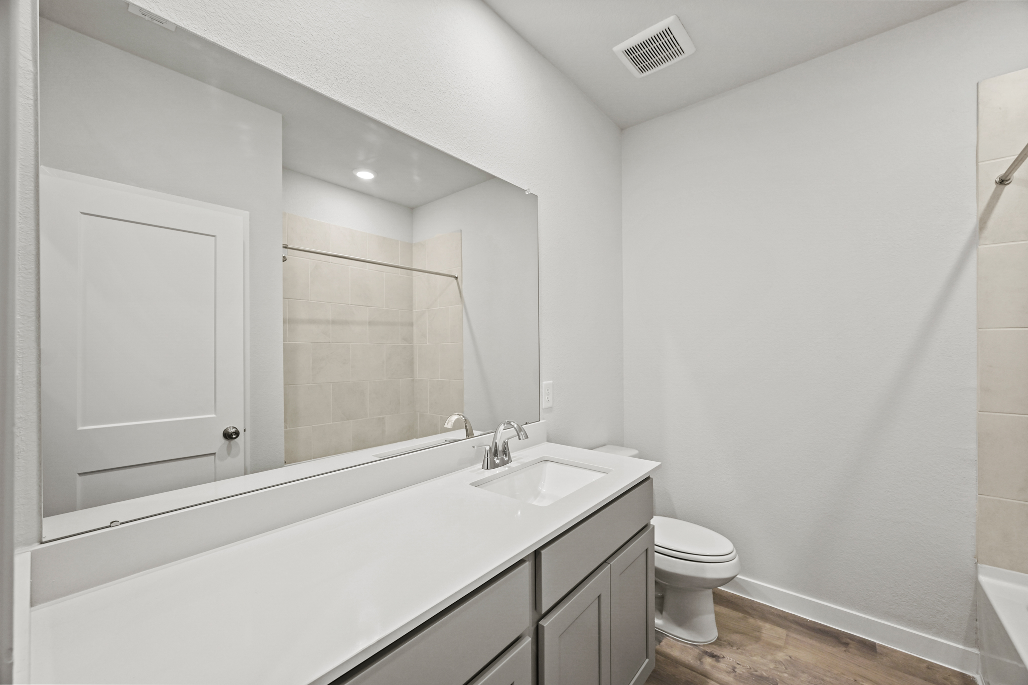 A bathroom with a tub sink and toilet.