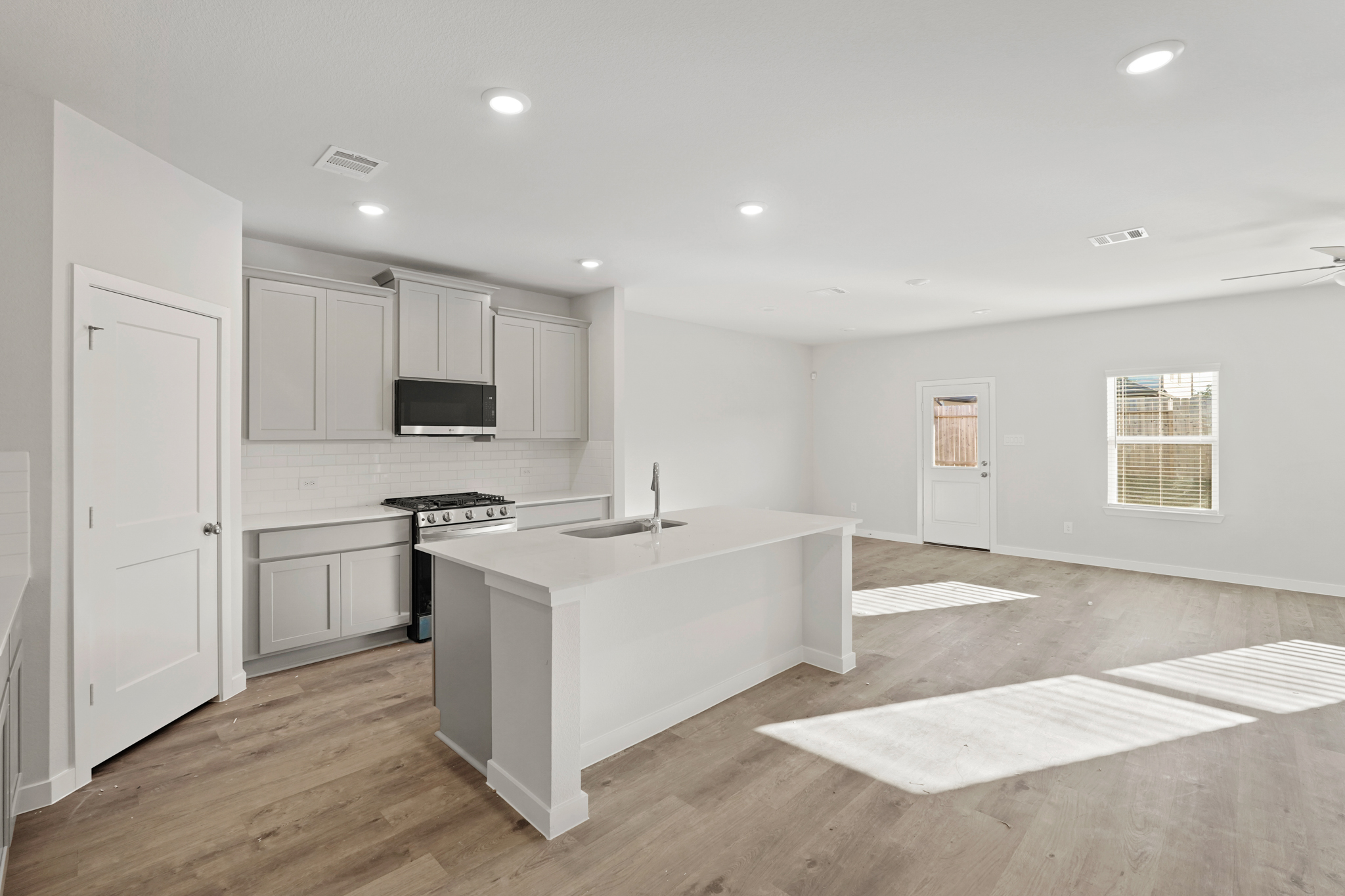 A kitchen with white cabinets.