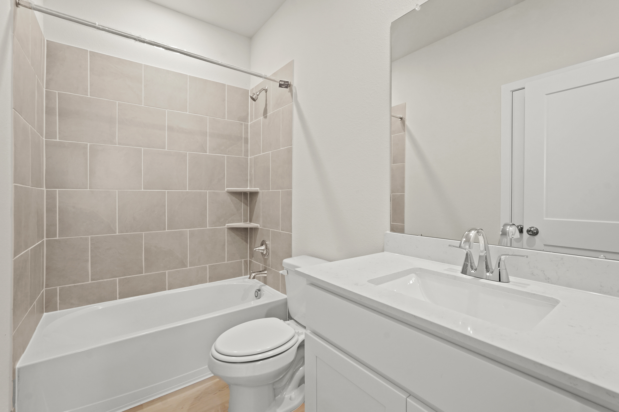 A bathroom with a tub sink and toilet.