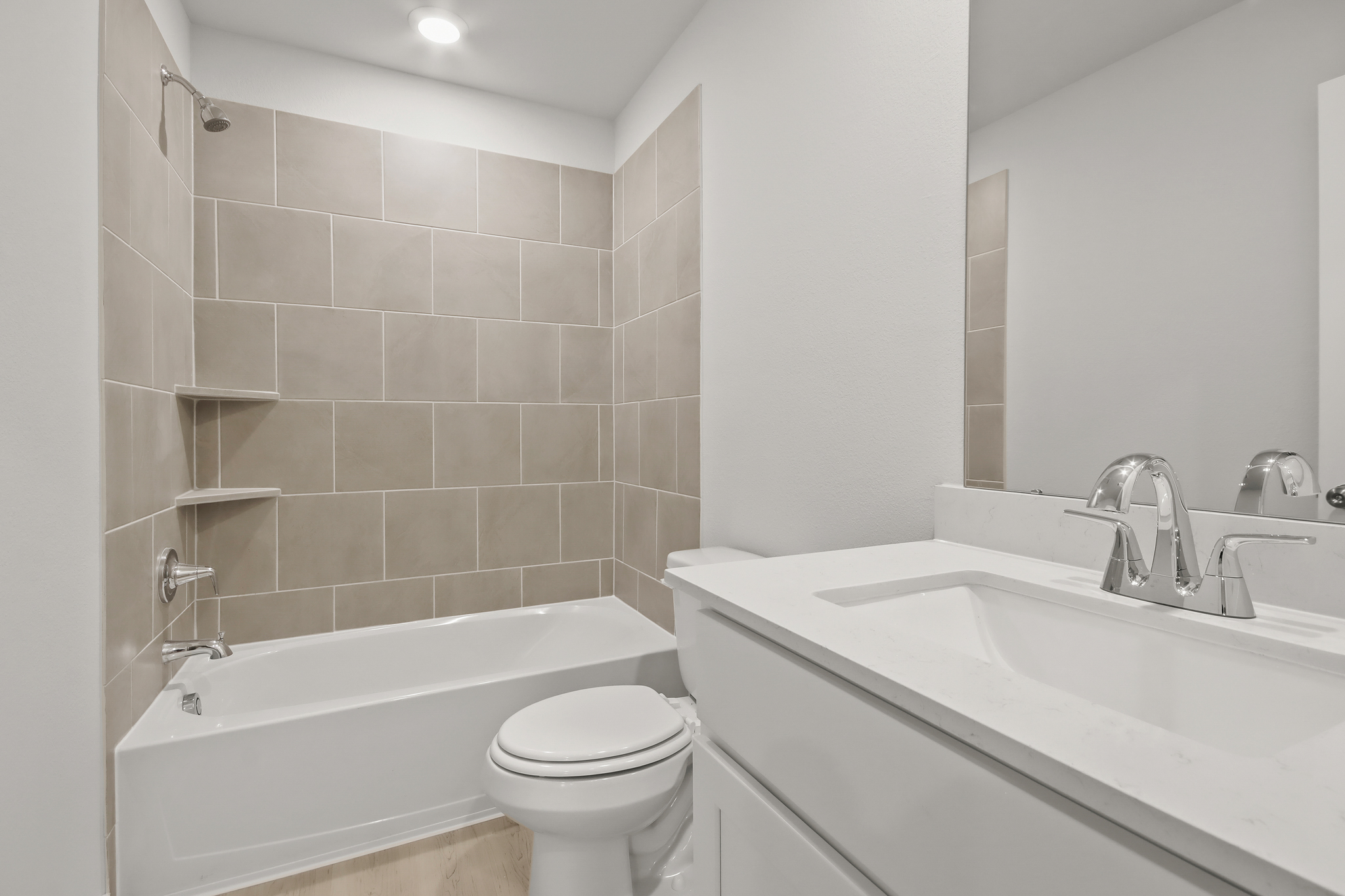 A bathroom with a tub toilet and sink.