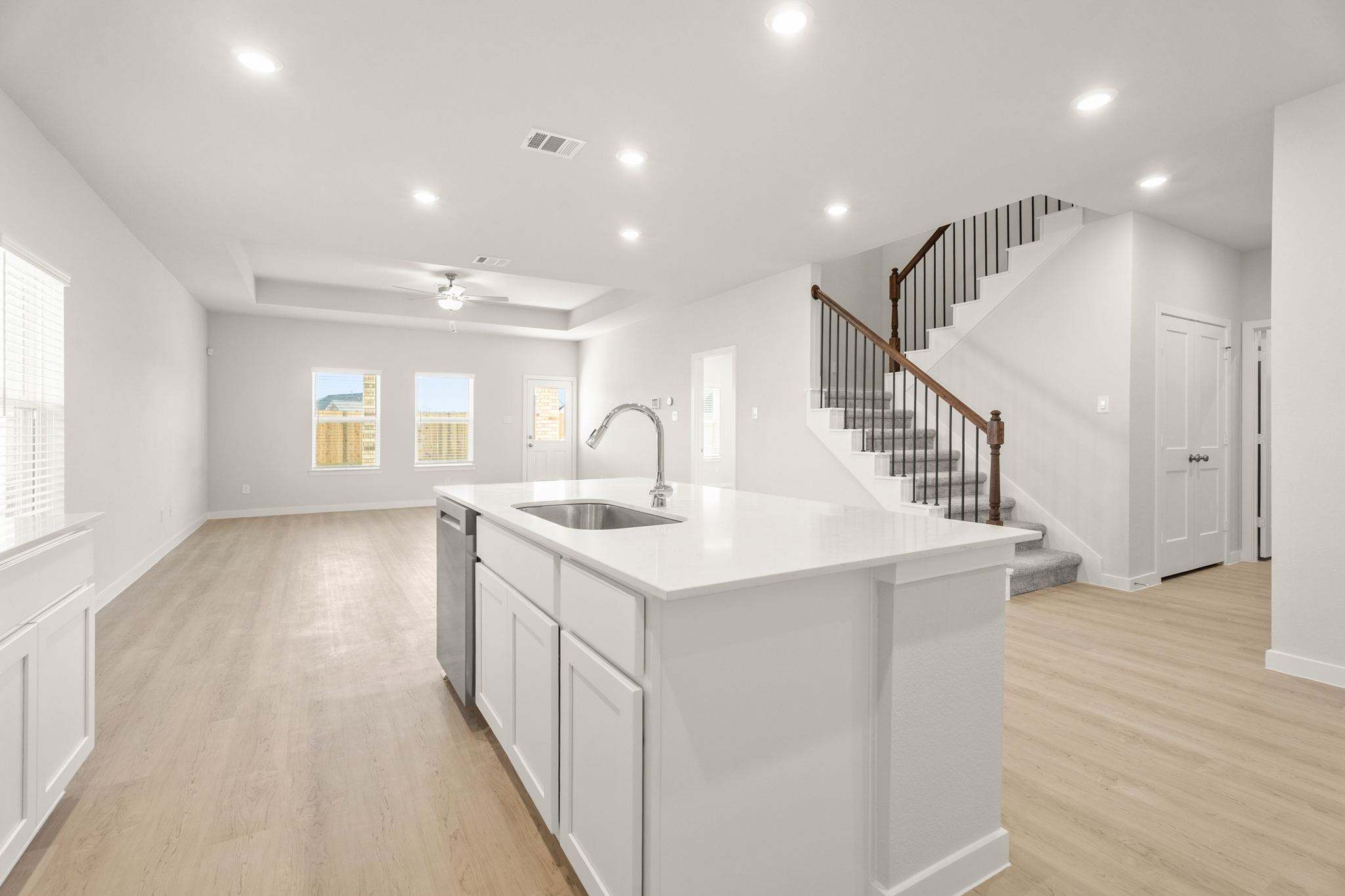 A kitchen with white cabinets.
