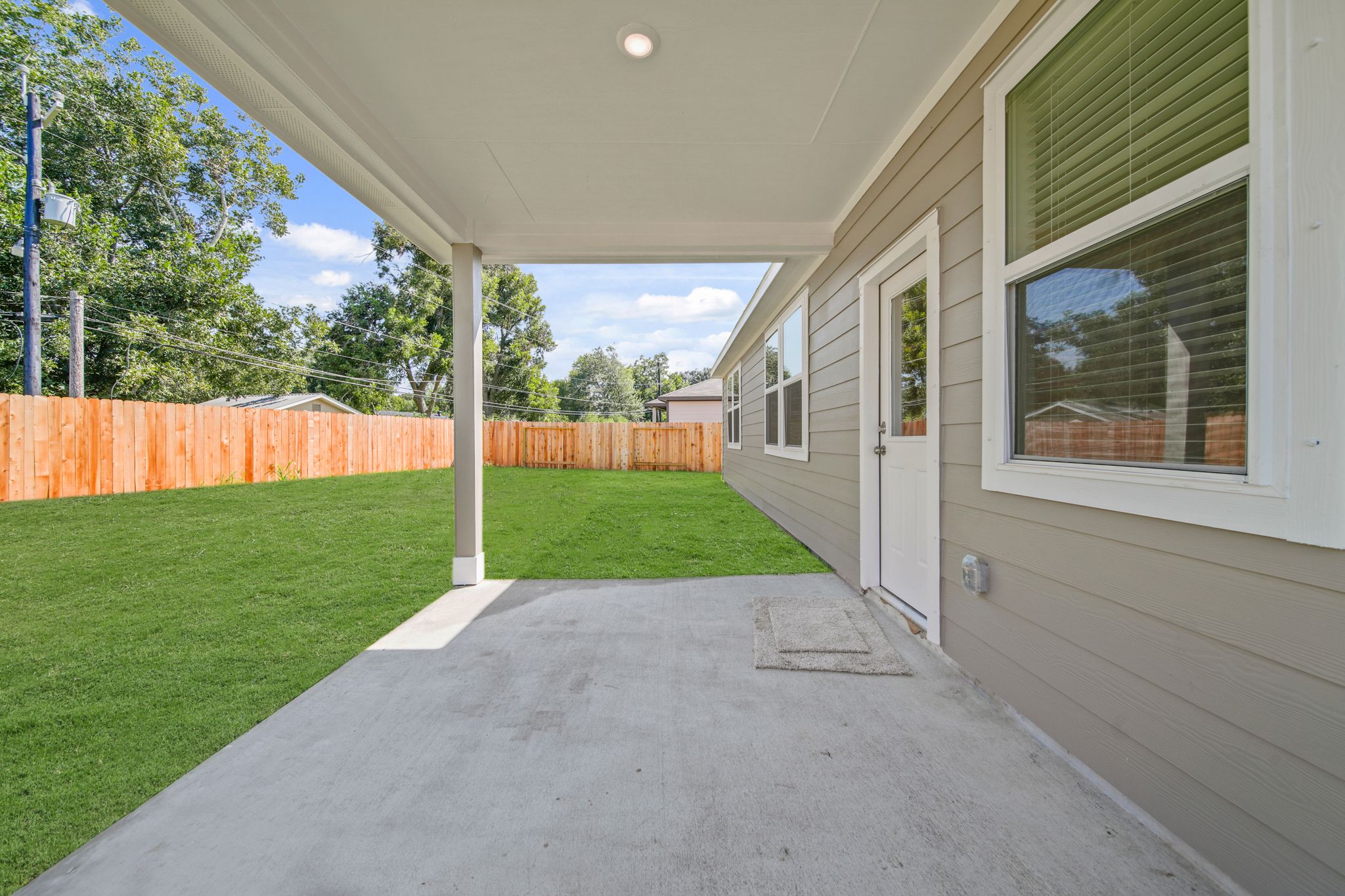 A house with a fence and grass.