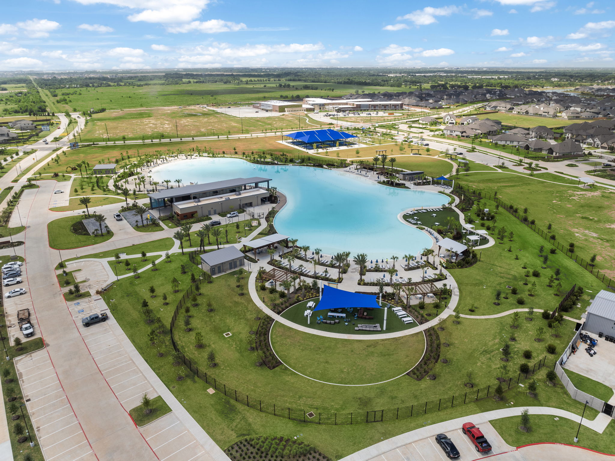 A large building with a pool in the middle of a field.