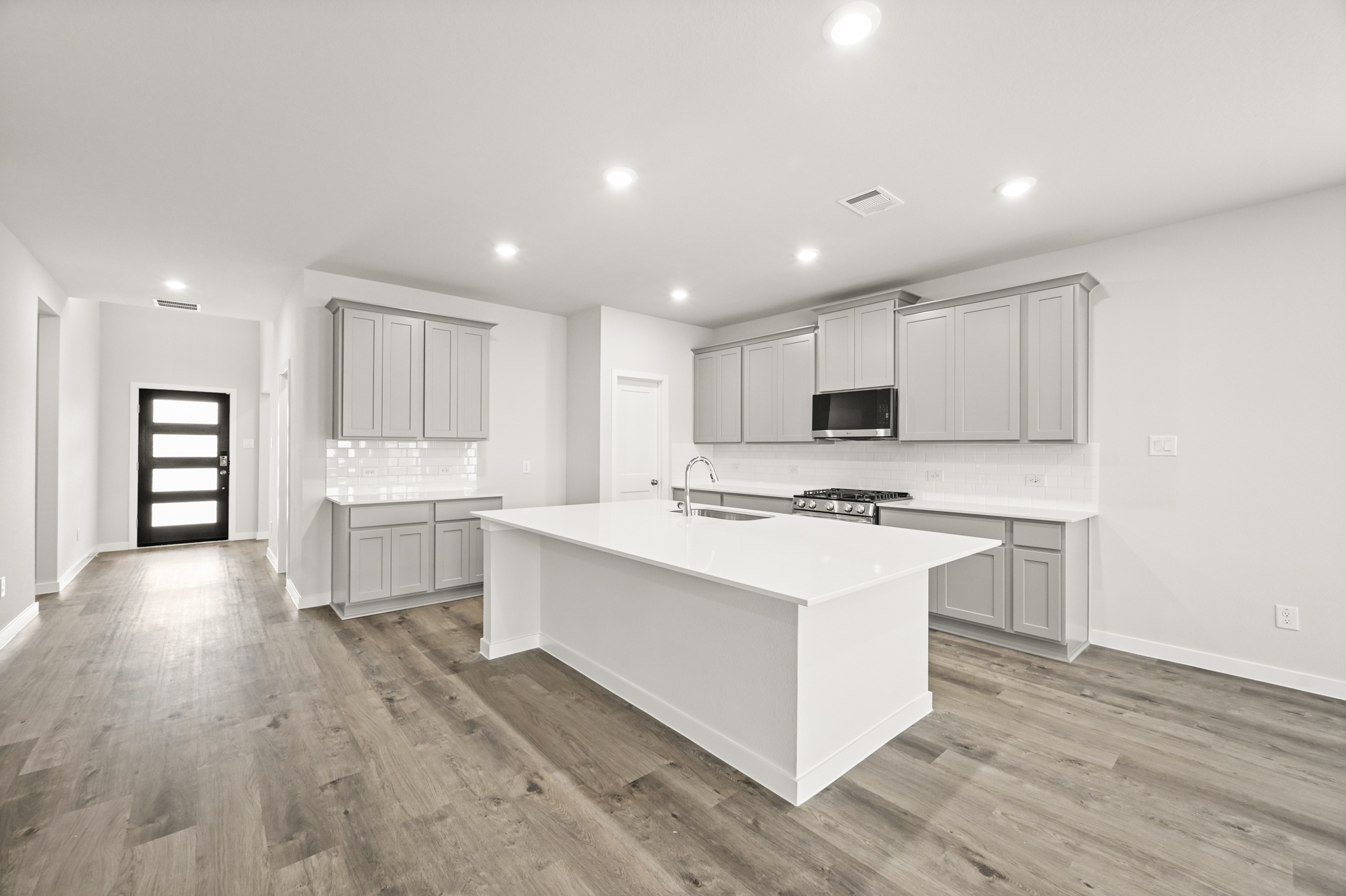 A kitchen with white cabinets.